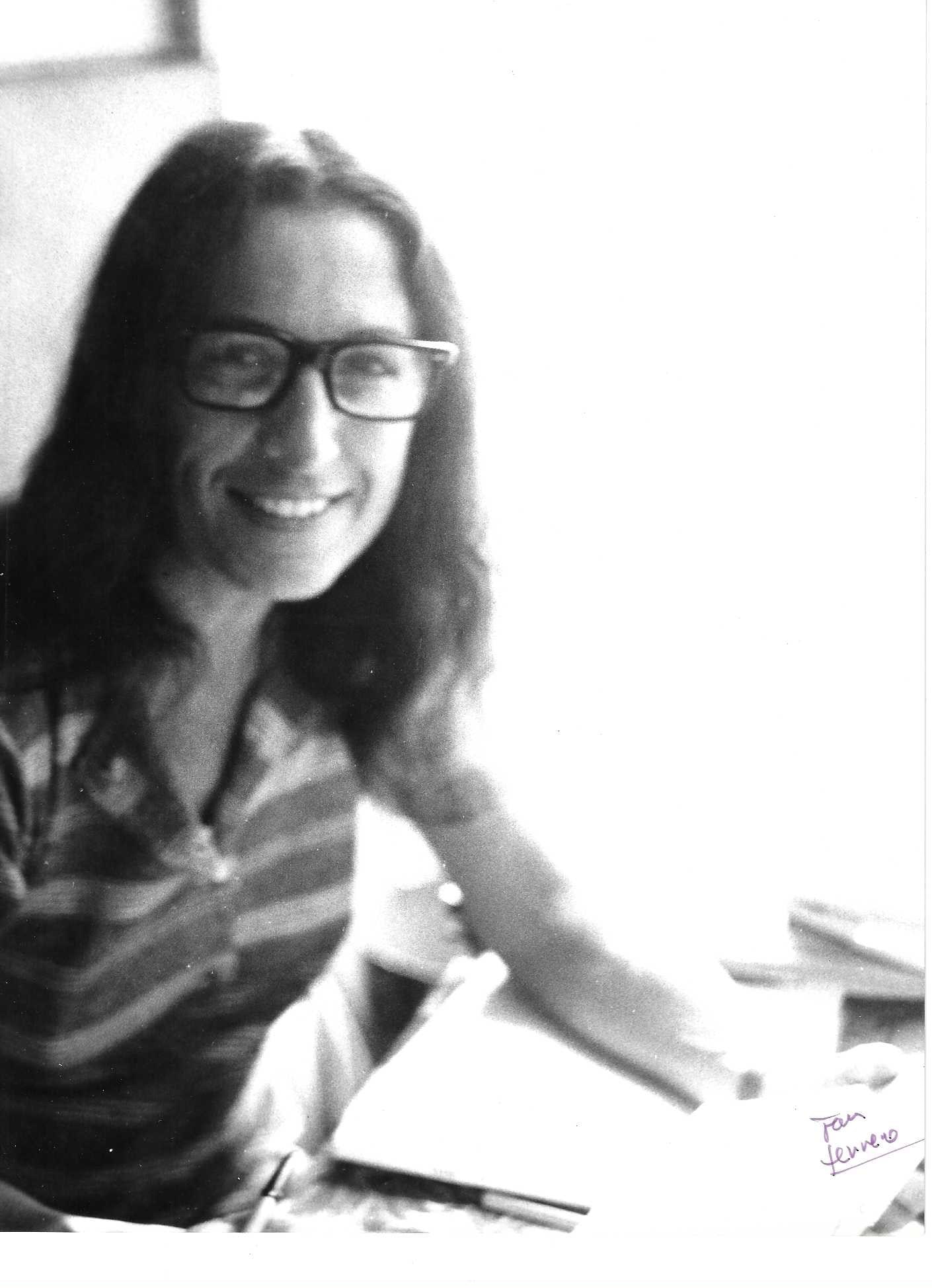 Jean Ferrero - Portrait of Milena Milani: A vintage black-and-white portrait of Milena Milani, taken by photographer Jean Ferrero (1931?2021), showing her smiling, with her characteristic long hair and eyeglasses, in a moment of apparent dome