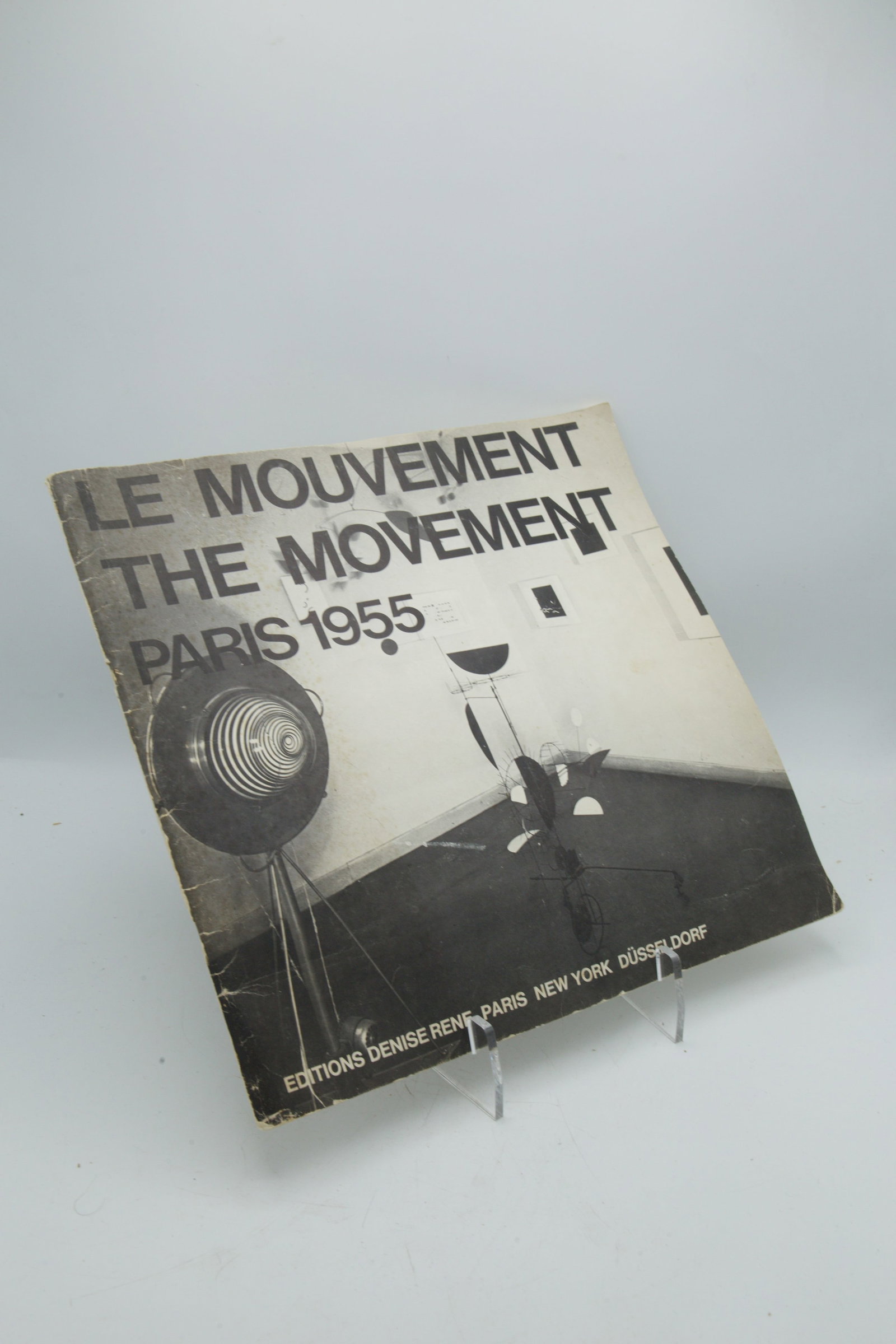 Le Mouvement: Catalog of the kinetic art exhibition ?Le Mouvement,? originally held in Paris in 1955 at the Galerie Denise Ren?. The catalog pictured is a 1975 edition published to mark an anniversary of the