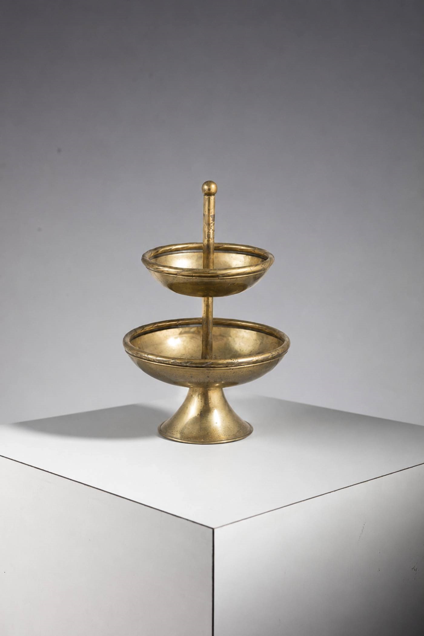 Manifattura Italiana Centrepiece: Height: 52 cm Diameter: 34 cmBrass etagere made in the 1950s, of fine Italian manufacture.The fruit stand is made entirely of original brass, with typical brass punches.