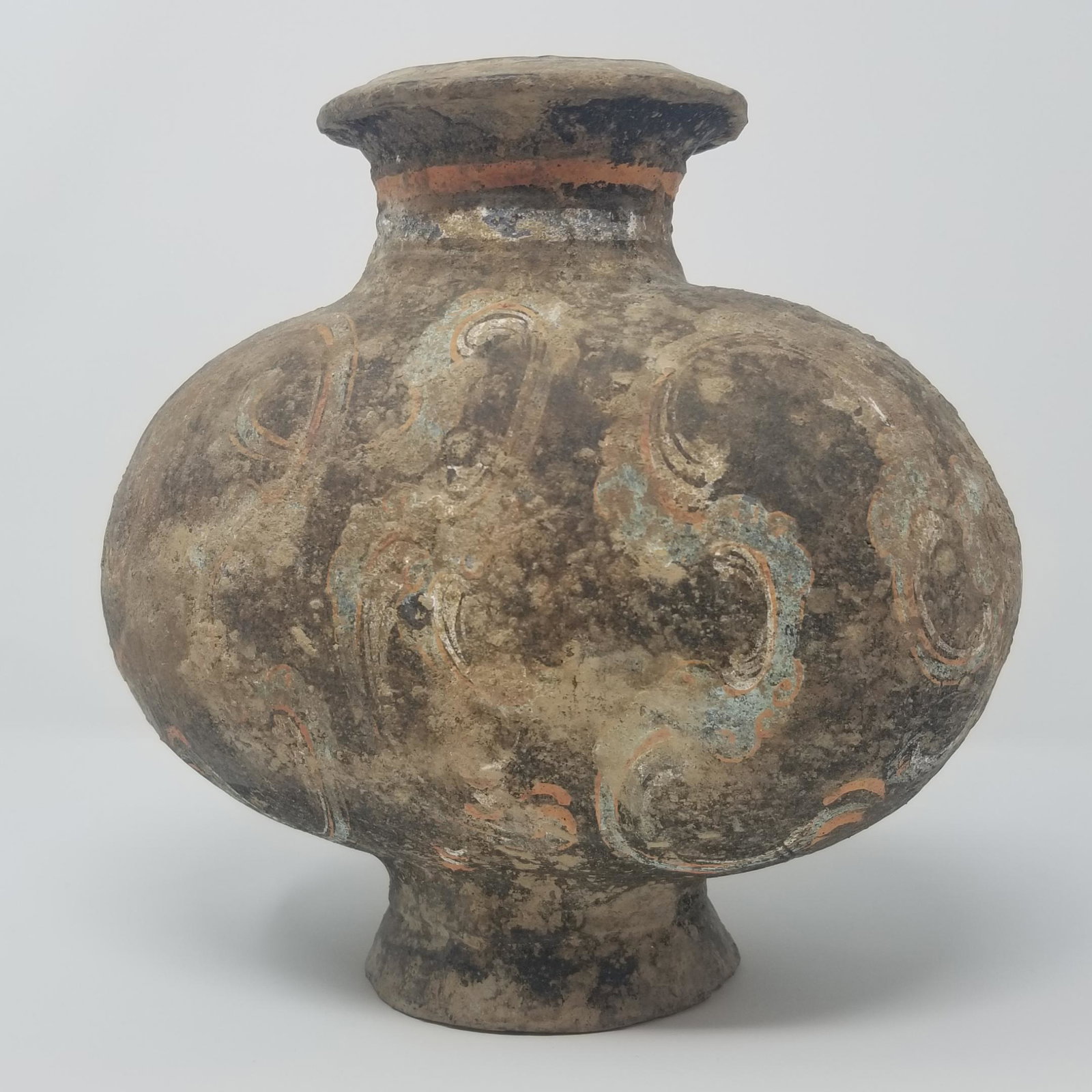 Cocoon Jar - Han Dynasty: From the Han Dynasty (206 BCE - 220 CE), China. A painted earthenware vessel. Painted S-scrolls in red, blue and white. 9 inches in height. Provenance - ex. private Toronto Collection, Sold Ritchies A