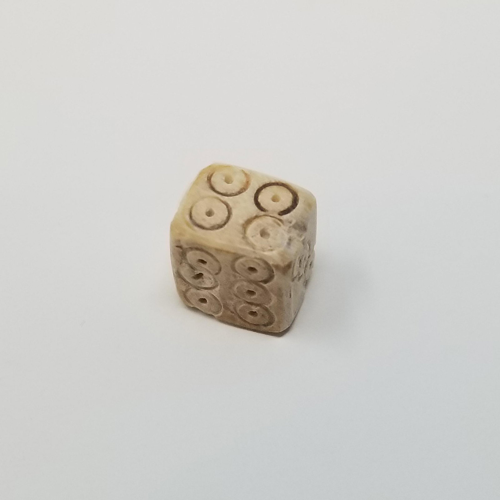 Bone Dice - Roman Empire: From Ancient Rome, a small bone dice (1/2 inch) from the 1st-3rd Century CE. Used likely by soldiers to gamble while at camp. Bone is likely from Ox. Provenance - ex. Private collection of UK Gentlema