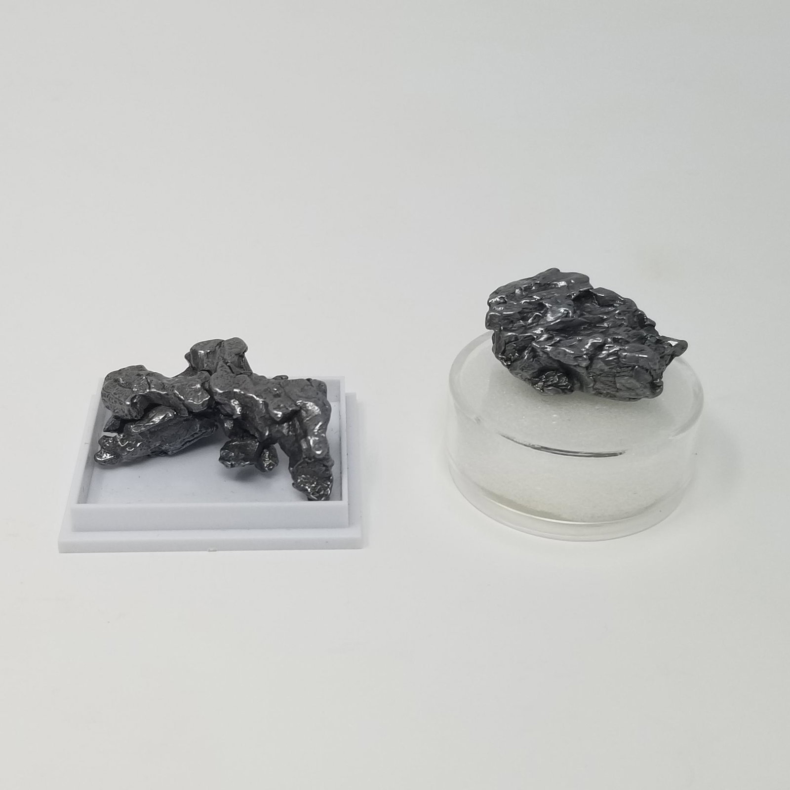 Campo del Cielo Meteorite (2): Description: 2 small Campo del Cielo Meteorites, see picture. One piece has a loose bit, but is still connected. 25 grams+ Provenance: ex. IMCA dealer, USA All purchases will be accompanied by a signe