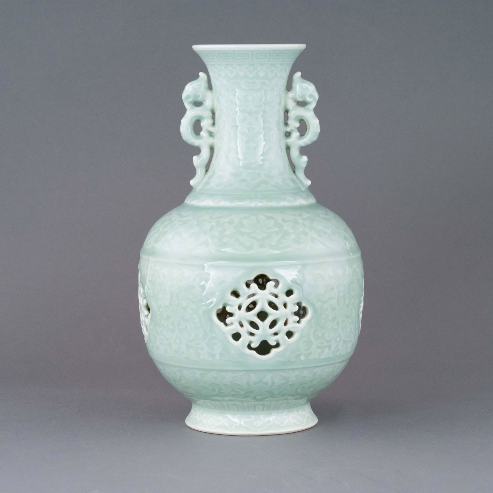 QIANLONG PIERCED DRAGON CELADON GLAZED AMPHORA VASE: Dimensions: Height: 12.125 inch x Width/Diameter: 6.875 inch x Length/Depth: 6.875 inch Dimensions in Centimeter: 30.8 cm x 17.5 cm x 17.5 cm Lustrous, Chinese Qing Dynasty Period, Qianlong pierced dr