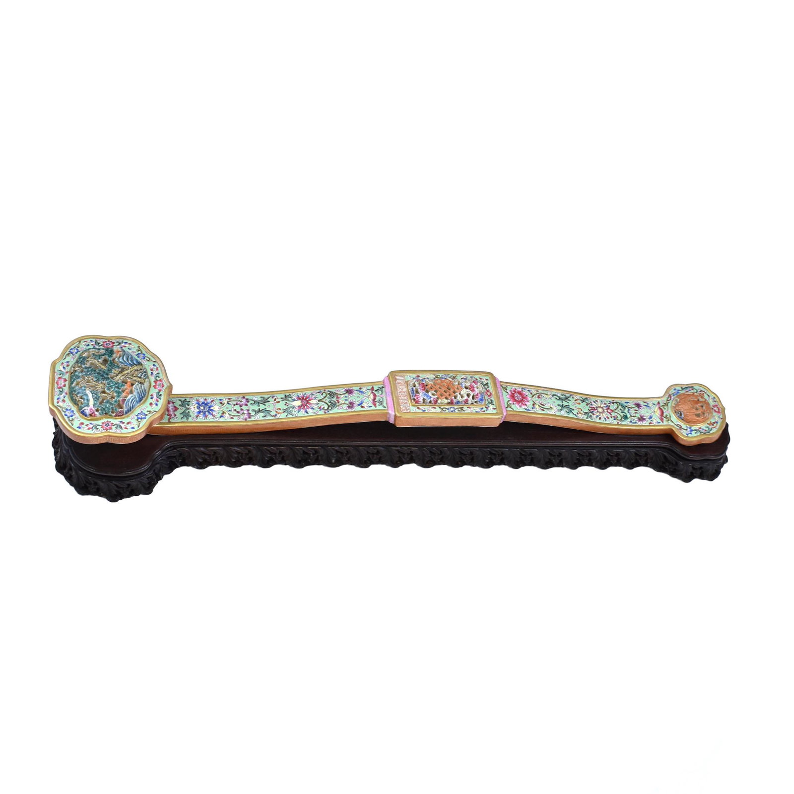 QING CRAVED FAMILLE ROSE PORCELAIN RUYI ON STAND: Dimensions: 21-7/8" L x 4-1/8" W Stand: 1-3/8" H Qing Dynasty enamel decorated open-works carved famille rose porcelain Ruyi Scepters. The wand delicately decorated in colorful Early Treasures and lot