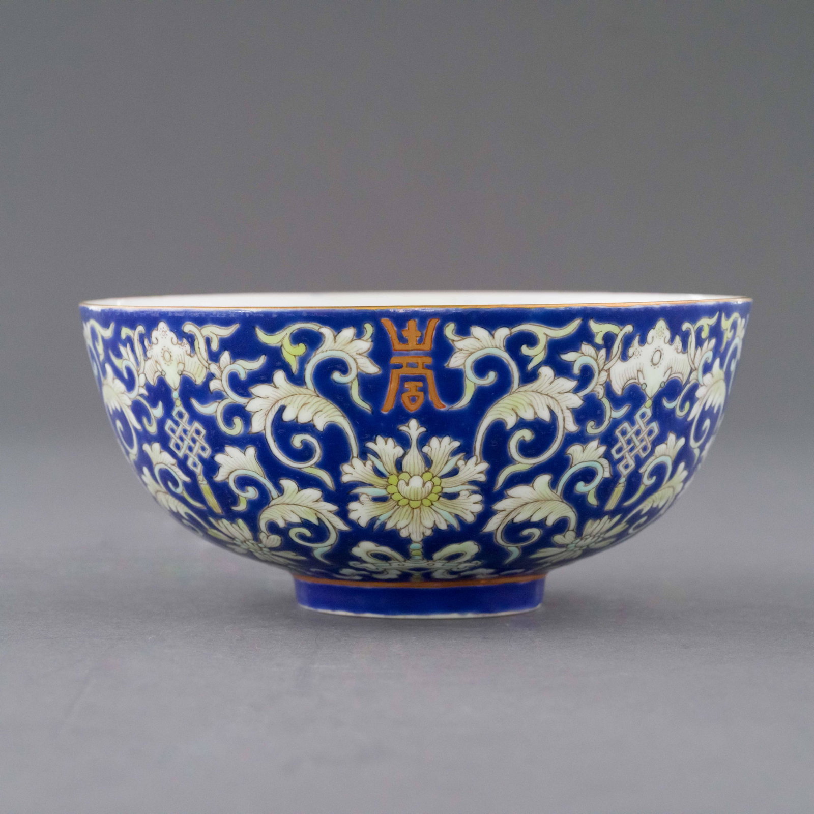JIAQING ROCOCO UPTALA MOTIF BOWL: Chinese Qing Dynasty Jiaqing rococo uptala motif porcelain bowl. The porcelain potted with a shallow body, of a shallow vessel, broad wide cavetto, with a straight opening lip, raised on a round sligh