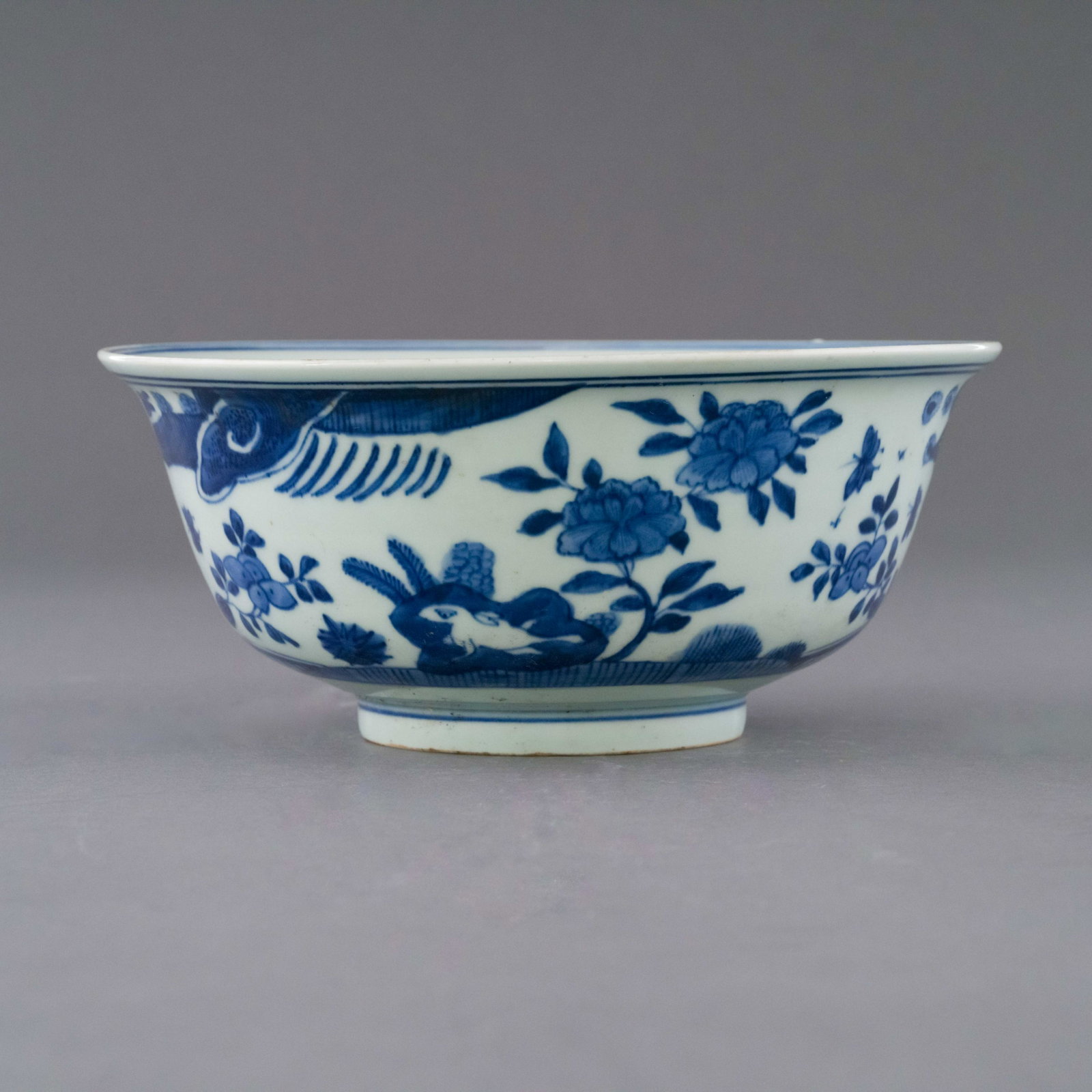 WANLI BLUE AND WHITE FRUIT ABUNDANT BOWL: Chinese Ming Dynasty Wanli blue and white fruit abundant motif porcelain bowl. The porcelain potted with a shallow body, of a shallow vessel, broad wide cavetto, with a flaring opening lip, raised on 