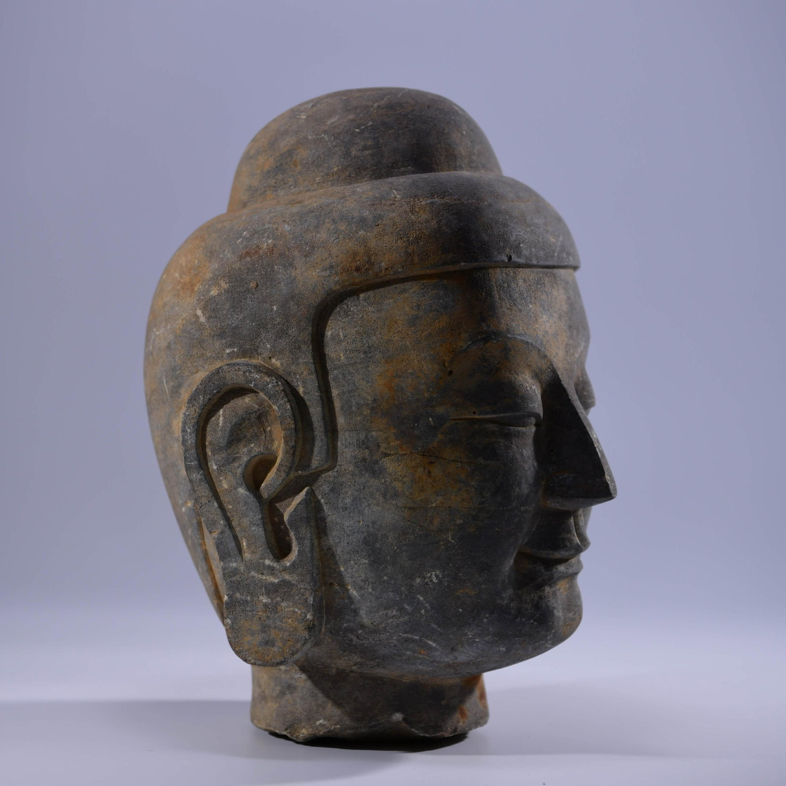 A CHINESE CARVED STONE BUDDHA'S HEAD: PROVENANCE: From the estate of Mrs. Harriet P. collections, Logansport , IN, most items was collected from BELL Antiques, Logansport, Indiana during early 20th C. A Chinese Carved Stone Buddha's Head.