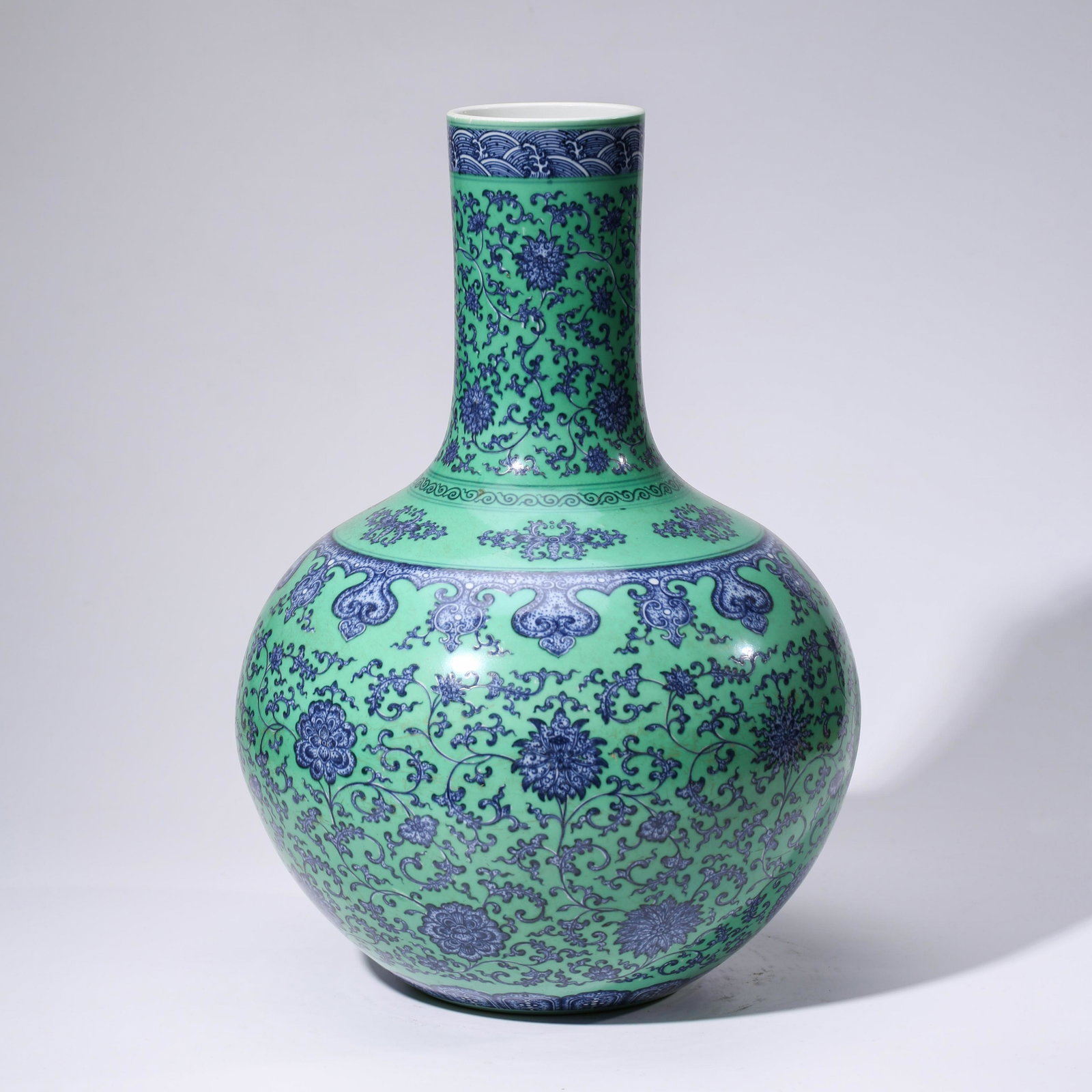 A CHINESE GREEN-GROUND PORCELAIN INTERLOCK BRANCHES: Dimensions: Diam.32.8cm, Height: 46.6cm, PROVENANCE: From the estate of William Schultz (1934 - 2018) of Alpharetta, Georgia. A Veteran, Private collectors. The vase is superbly potted with a globular