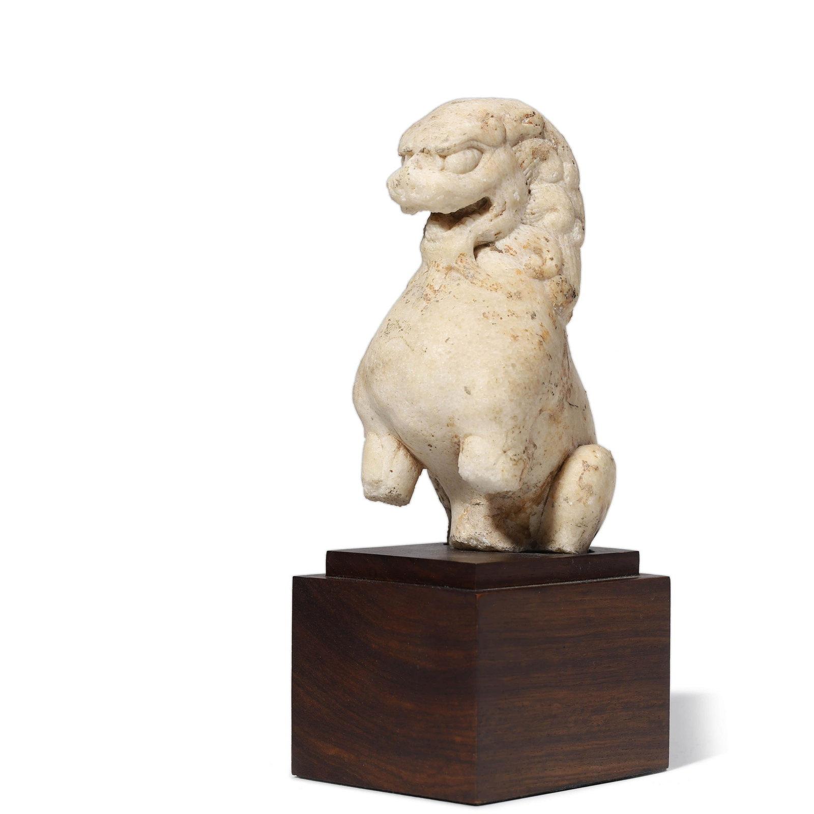 A Carved Stone of Buddhist Lion: Provenance: From private collector, acquired from HONGKONG in 1970s.. Dimensions: Width: 7.5cm, Height: 20.5cm A Carved Stone of Buddhist Lion . The beast modelled with a ferocious expression, with a 