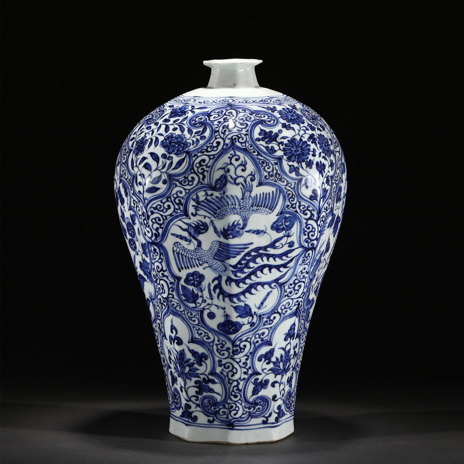 A BLUE AND WHITE PORCELAIN VASE: A BLUE AND WHITE PORCELAIN VASE 24.5 cm L x 41.2 cm H Rising from a slightly splayed foot to a high-shoulder body blow a short, waisted neck, painted phoenix against sprays in reserved windows, all be
