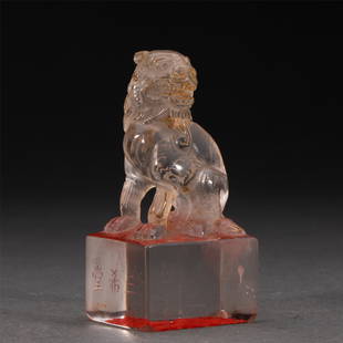 A CHINESE CRYSTAL SEAL: A CHINESE CRYSTAL SEAL 4.5 cm L x 4 cm W x 9.5 cm H x Weight 230 gram. The square base is surmounted by a beast, with inscription at the side, the stone is of transparent tone.