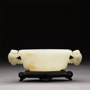 A CHINESE JADE BOWL: A CHINESE JADE BOWL 13.5 cm L x 8 cm W x 4 cm H x Weight 170 gram. The censer is raised on a circular support and flanked by two kid-handles. The semi-translucent stone is of a pale white