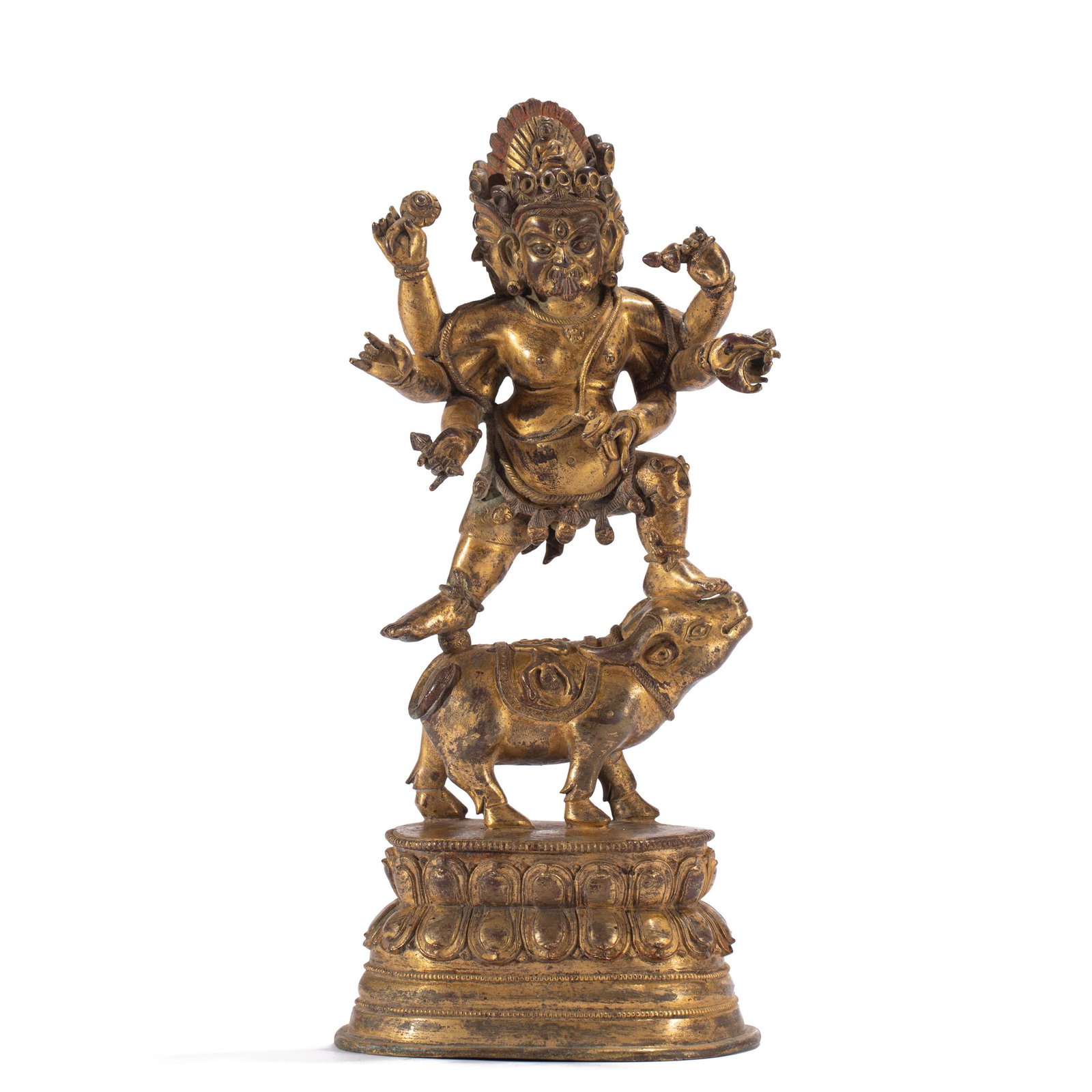 A TIBETAN GILT BRONZE FIGURE OF PROTECTOR: A TIBETAN GILT BRONZE FIGURE OF PROTECTOR 11 cm L x 8.5 cm W x 26 cm H x Weight 1310 gram. stepping to the right in alidhasana trampling on a bovine, with three heads and six arms, each face with a th