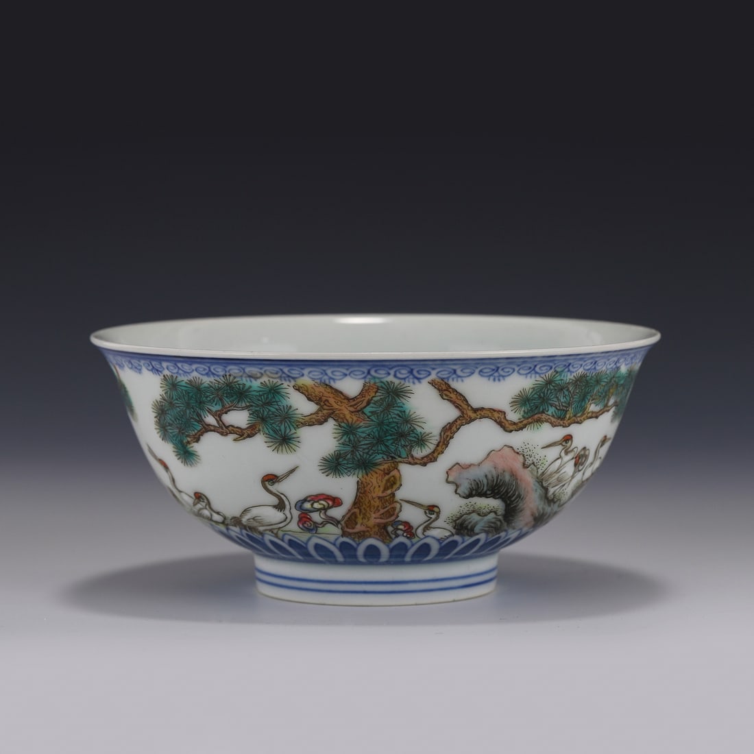 FAMILLE ROSE CRANES MOTIF BOWL: Measurements: Height: 6.6 cm Diam: 14.8 cm Chinese Qing Dynasty Period, QianLong amille rose cranes motif porcelain bowl. Potted with a shallow body, has an open mouth, deep arced body, raised on smal