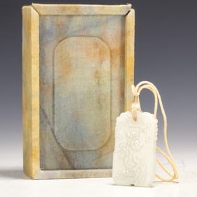 A CARVED WHITE JADE PLAQUE