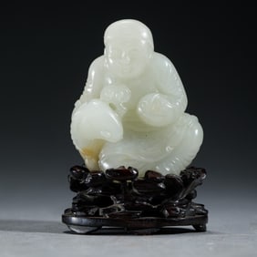 A WHITE JADE CARVING OF FIGURE