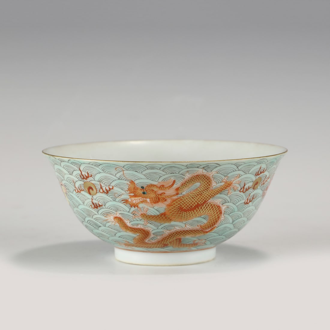 QING QIANLONG FAMILLE ROSE DRAGON BOWL: Measurements: Height: 6 cm, Diam: 13.2cm Chinese Qing Dynasty QianLong Famille Rose Dragon Porcelain Bowl. The porcelain potted with a shallow body, slight deep, thick, flaring rim with angled cavetto