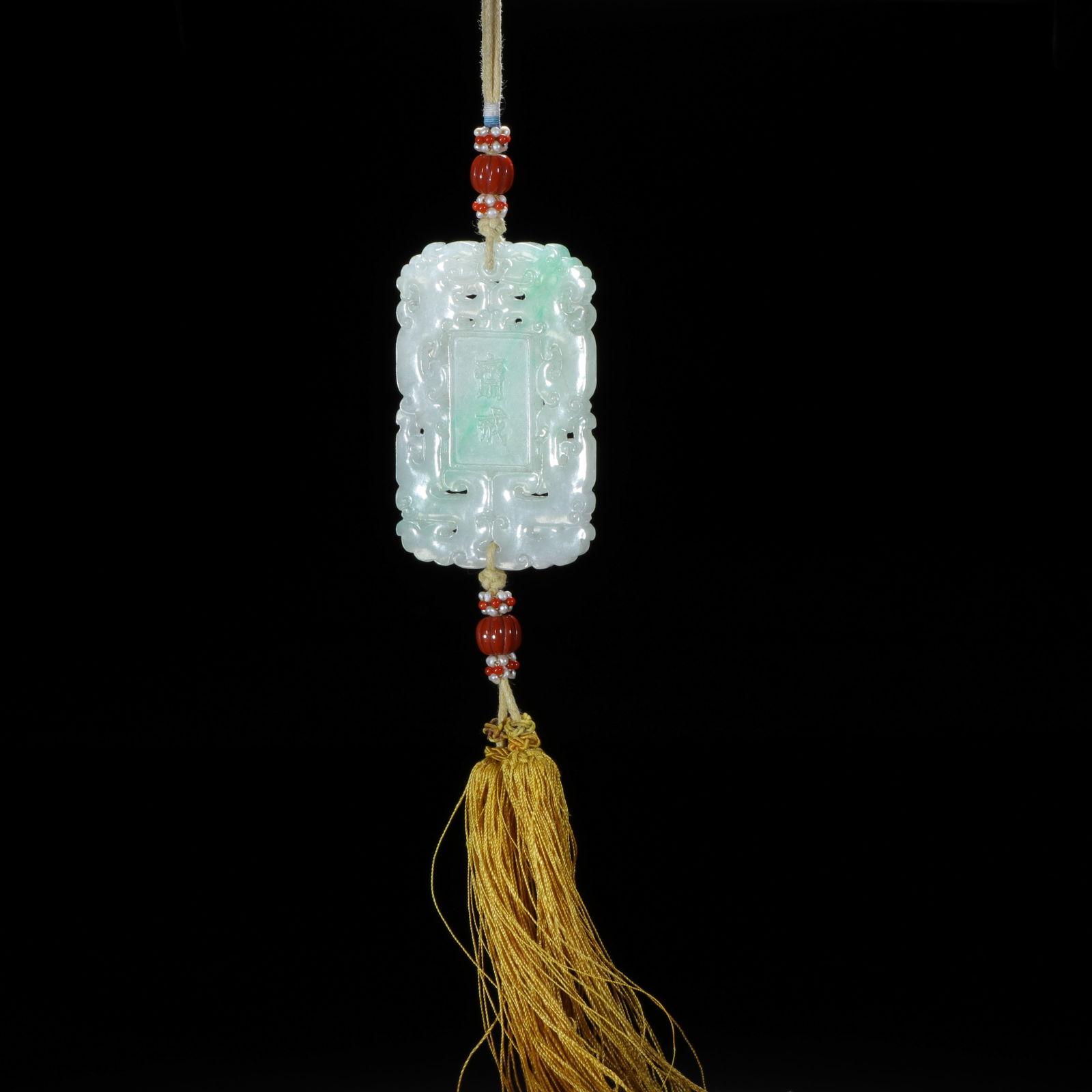 CHINESE JADEITE FASTING PLAQUE: Dimensions: L. 6.3 cm. W. 3.9 cm. This exquisite Chinese jadeite fasting plaque measures 6.3 cm in length and 3.9 cm in width, carved from translucent jadeite with delicate apple-green suffusions. The