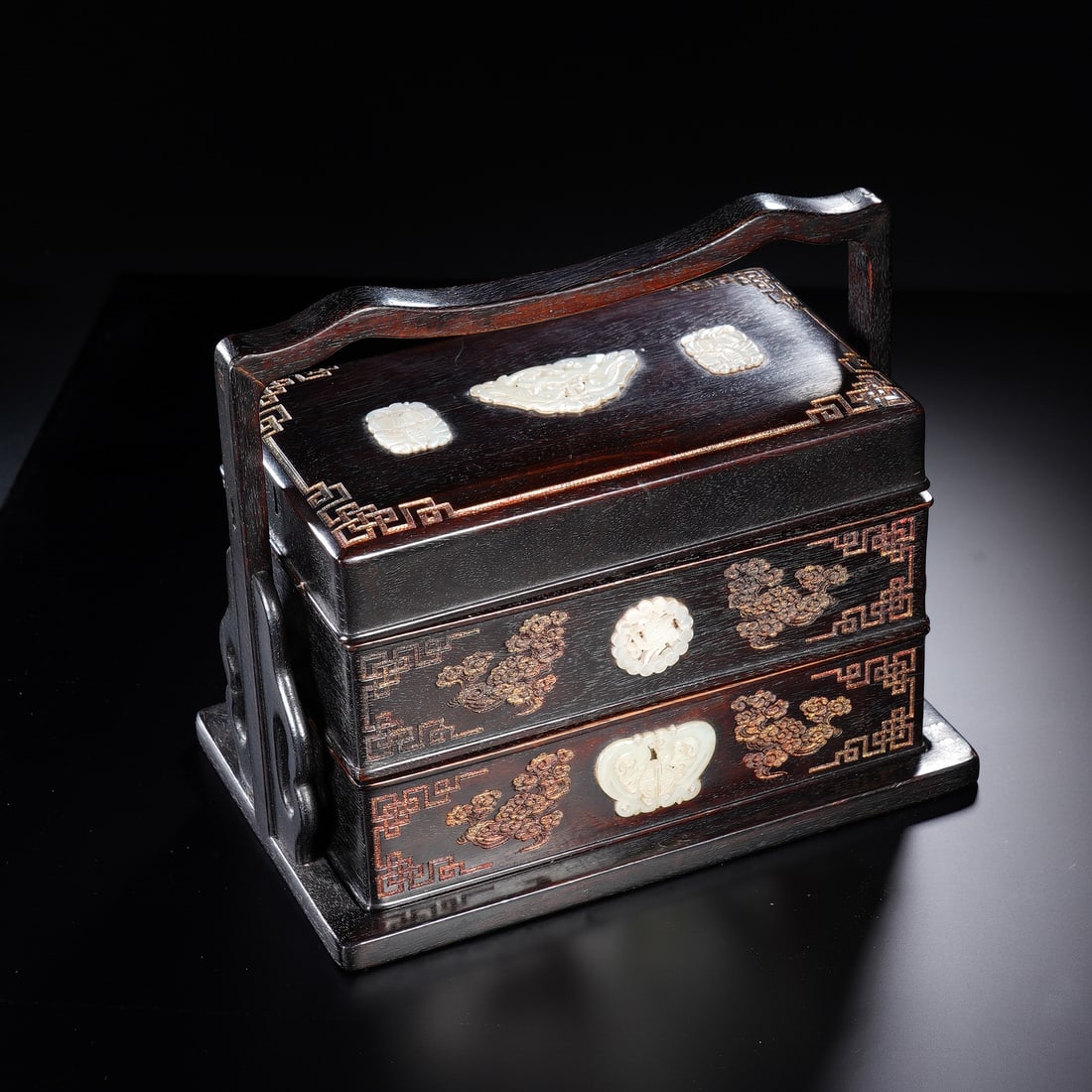 CHINESE ZITAN JADE-INLAID CARRY BOX: Dimensions: 20x12x16 cm. This Chinese zitan wood carry box features a tiered form with a curved handle, inlaid white jade medallions, and gilt metal wire filigree patterns, measuring 20 cm in length,