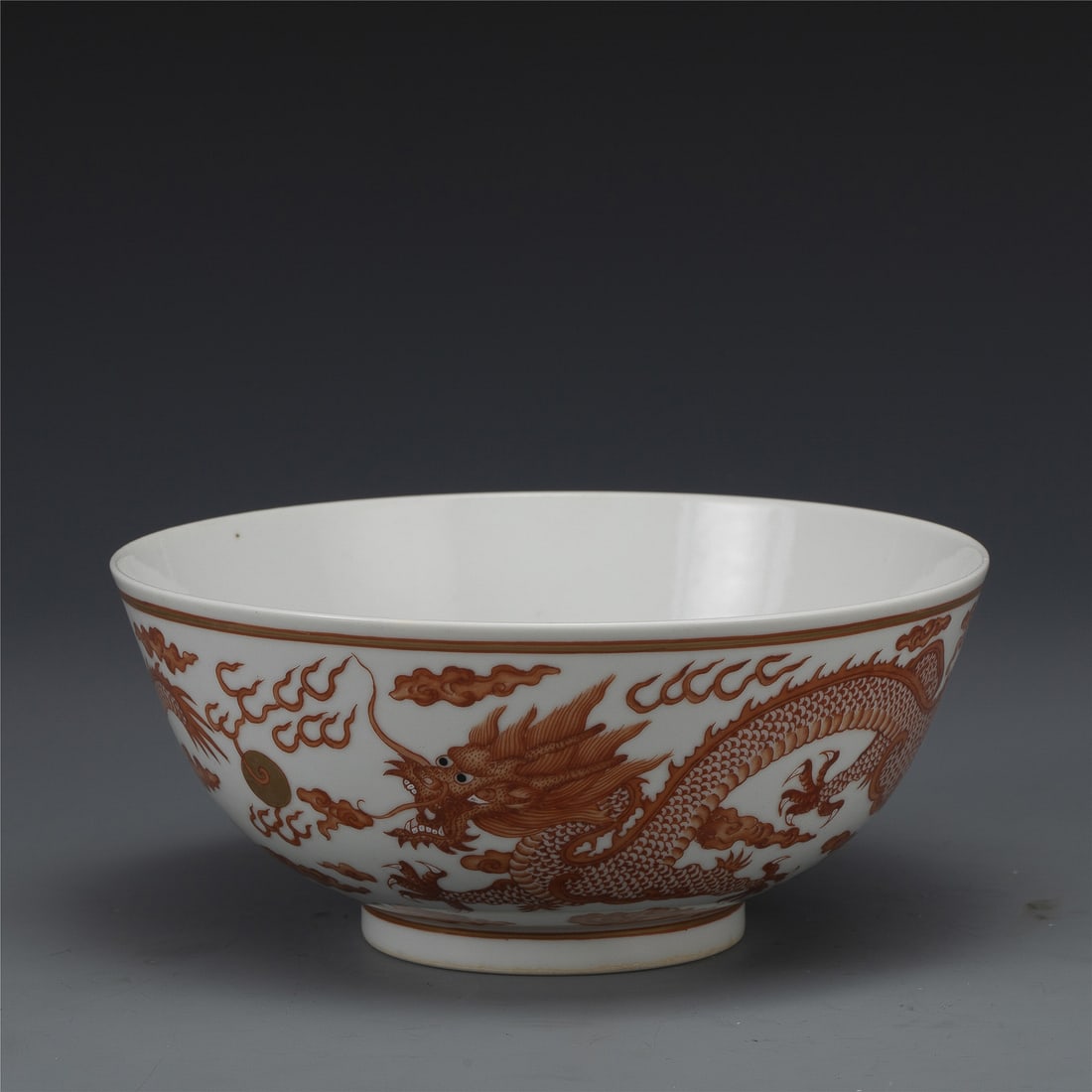 QING GUANGXU ALUM RED BOWL: Measurements: Width: 19.2 cm, Height: 8.5 cm Chinese Qing Dynasty Guangxu Alum Red Porcelain Bowl. Potted with a shallow body, slight deep, thick and bulbous body, with angled cavetto elevated the