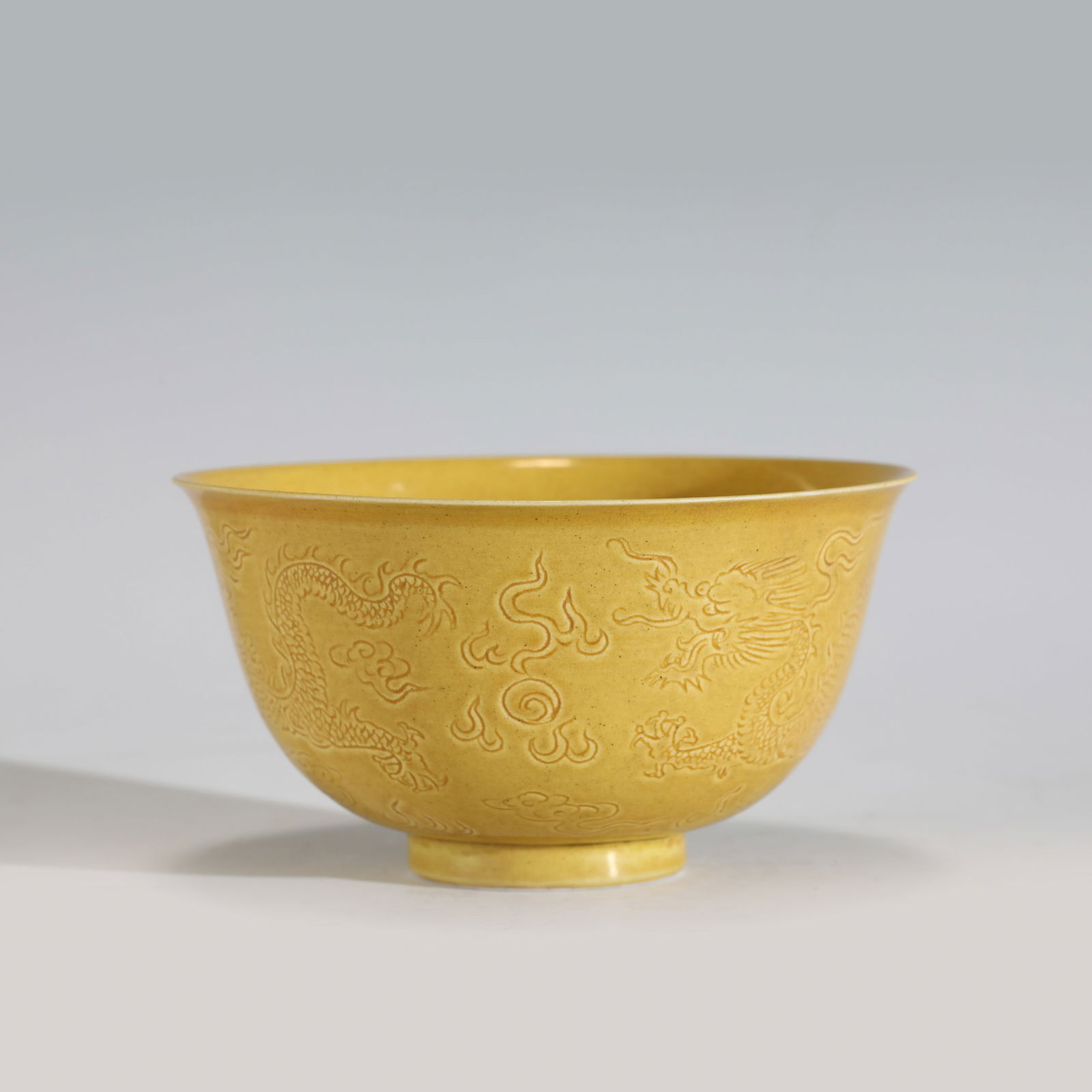 QING QIANLONG YELLOW GLAZED SGRAFITTO BOWL: Measurements: Height: 6.7 cm, Diam: 11.8cm Chinese Qing Dynasty Qianlong Yellow Glazed Porcelain Bowl. The porcelain potted with a shallow body, slight deep, thick, flaring rim with angled cavetto
