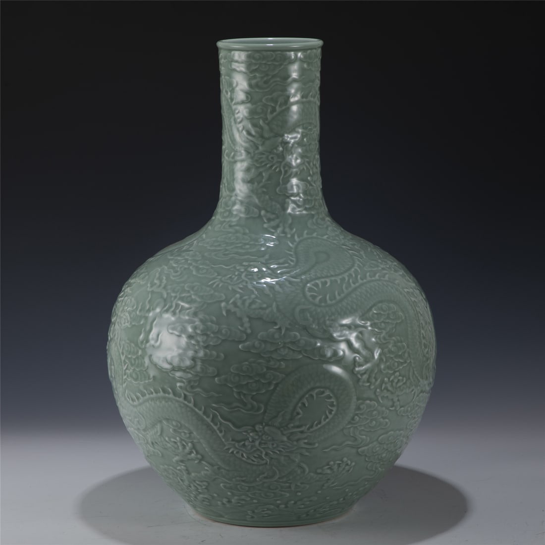 QIANLONG CARVED PORCELAIN CELESTIAL VASE: Measurements: Length: 38cm, Width: 38cm, Height: 54.6cm Chinese Qing Dynasty Qianlong Douqing Dragon Carved Porcelain Celestial Vase. Potted in celestial shape vase, thick and tall, globular lower