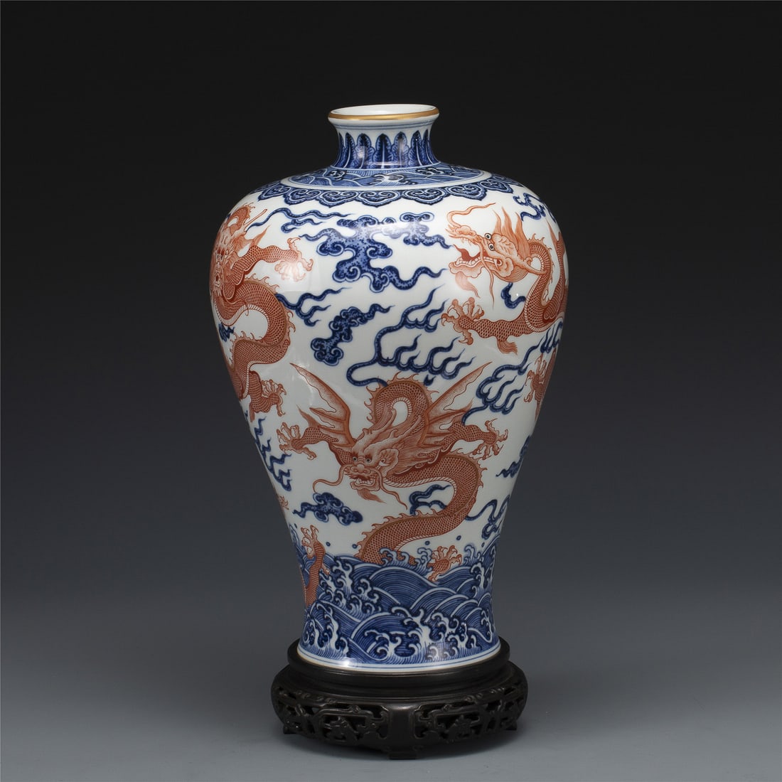 QIANLONG BLUE & WHITE ALUM RED PLUM VASE: Measurements: Width: 23 cm, Height: 35.2 cm Chinese Qing Dynasty Qianlong Blue and White Alum Red Porcelain Plum Vase On Carved Hardwood Stand. Potted into a traditional Meiping form, large, thick