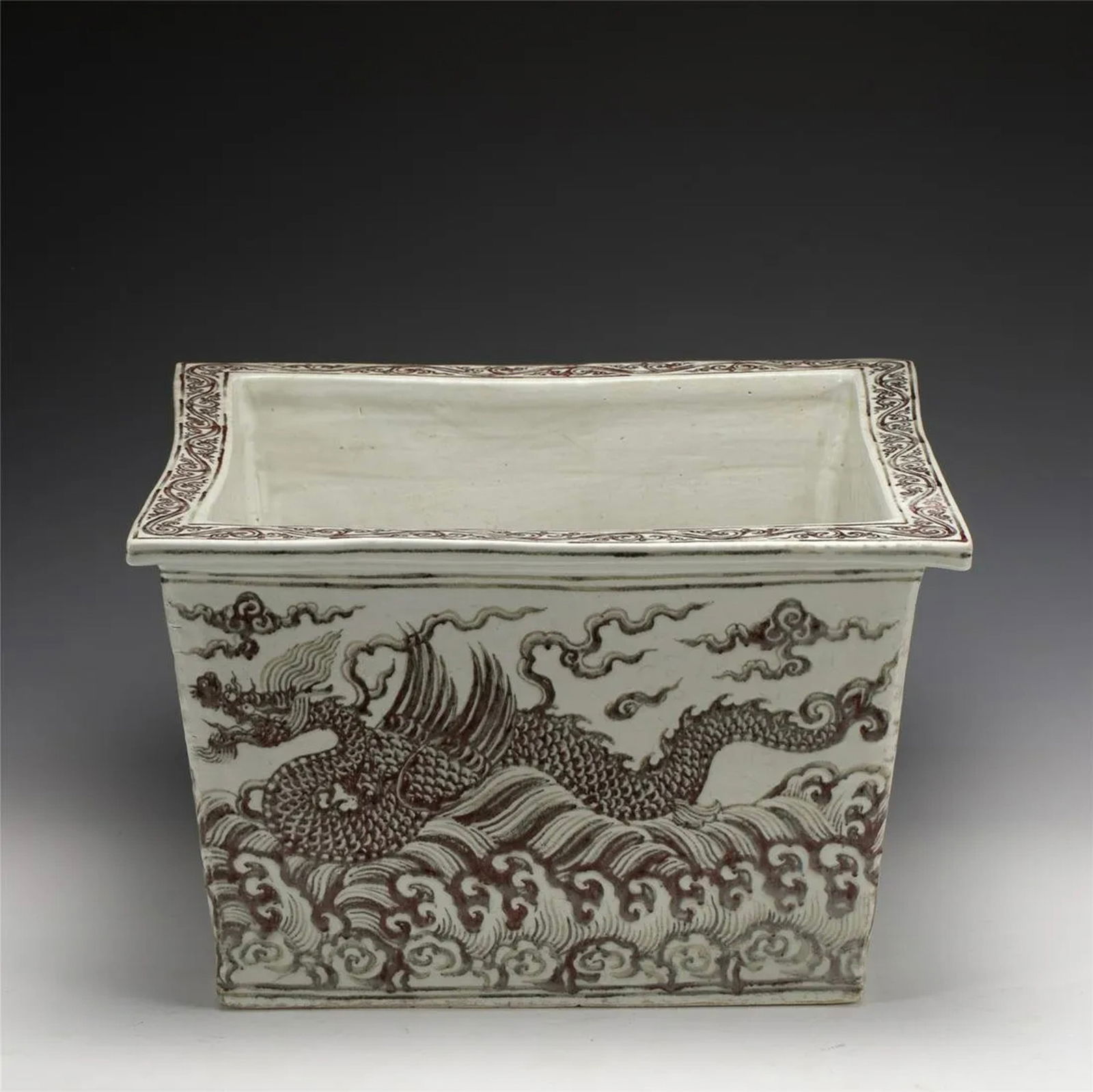 MING UNDERGLAZE RED SQUARE PLANT POT: Measurements: Length: 49.3 cm, Width: 49.3 cm, Height: 30.5 cm Chinese Ming Dynasty Underglaze Red Porcelain Square Plant Pot. Potted in tank water shape, sturdily in cylindrical straight body, thick