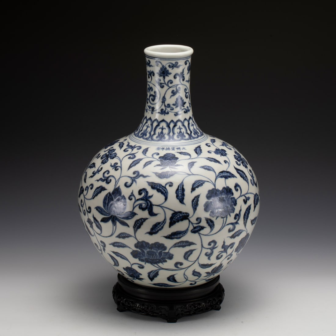 MING XUANDE BLUE & WHITE CELESTIAL VASE ON STAND: Measurements: Width: 32.5 cm, Height: 43.4 cm Chinese Xuande Blue and White Lotus Porcelain Celestial Vase On Carved Hardwood Stand. Potted in celestial shape, thick and tall, globular lower body, cyl