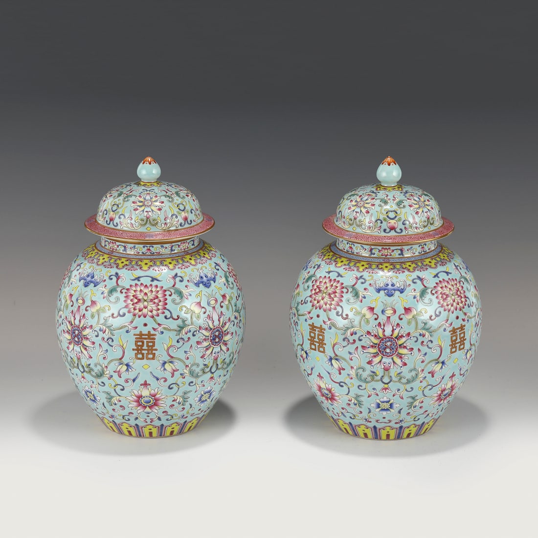 JIAQING FAMILLE ROSE LOTUS PORCELAIN LIDDED JARS: Measurements: Height: 27.5 cm, Diam.: 18 cm Pair of Chinese Qing Dynasty JiaQing Famille Rose Lotus Bloom Motif Porcelain Lidded Jars. This porcelain has an round open mouth with a slightly out-turned