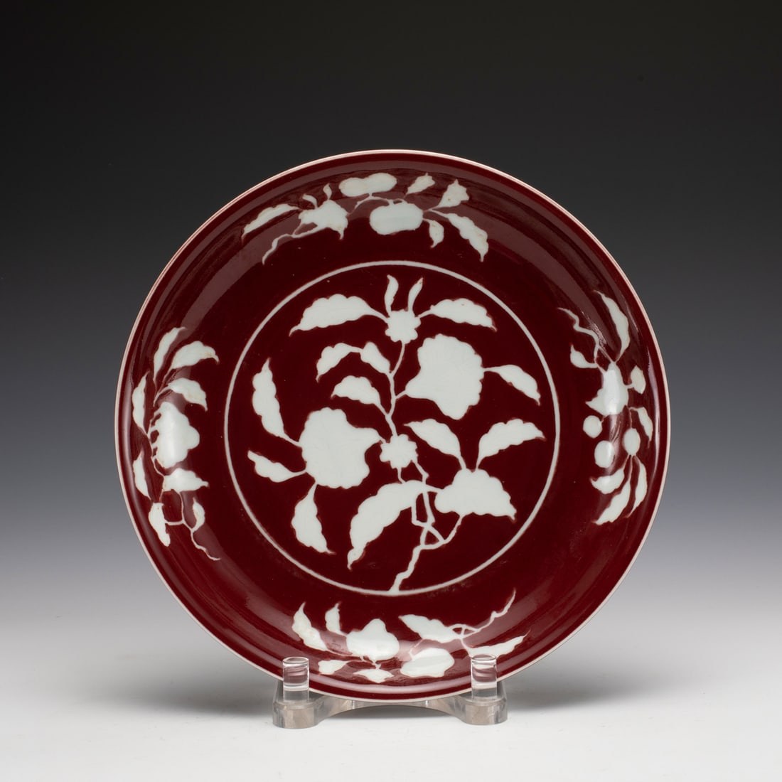 MING XUANDE ALUM RED PLATE: Measurements: Width: 32.8 cm, Height: 5.2 cm Chinese Ming Xuande Alum Red Flower Porcelain Plate. The plate has a broad wide central interior, round mouth lip, thick and large, raised on
