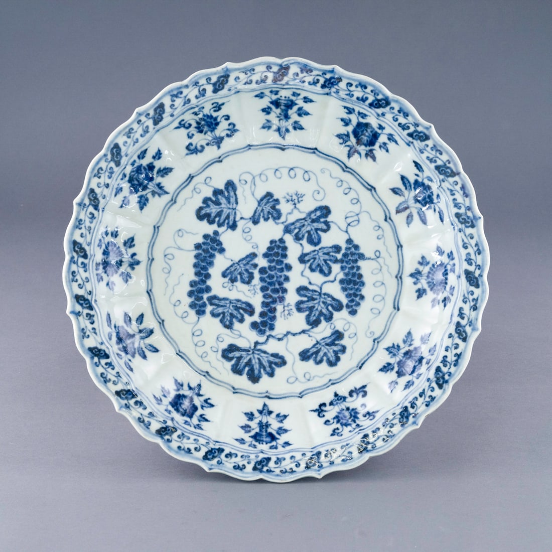 MING BLUE & WHITE GRAPES ABUNDANT PLATE: Measurements: 3in H x 16.75in W x 16.75in D Stunning, Chinese Ming Dynasty Period, blue & white grapes abundant plate. The Finest porcelain potted in shallow vessel form, with broad wide central