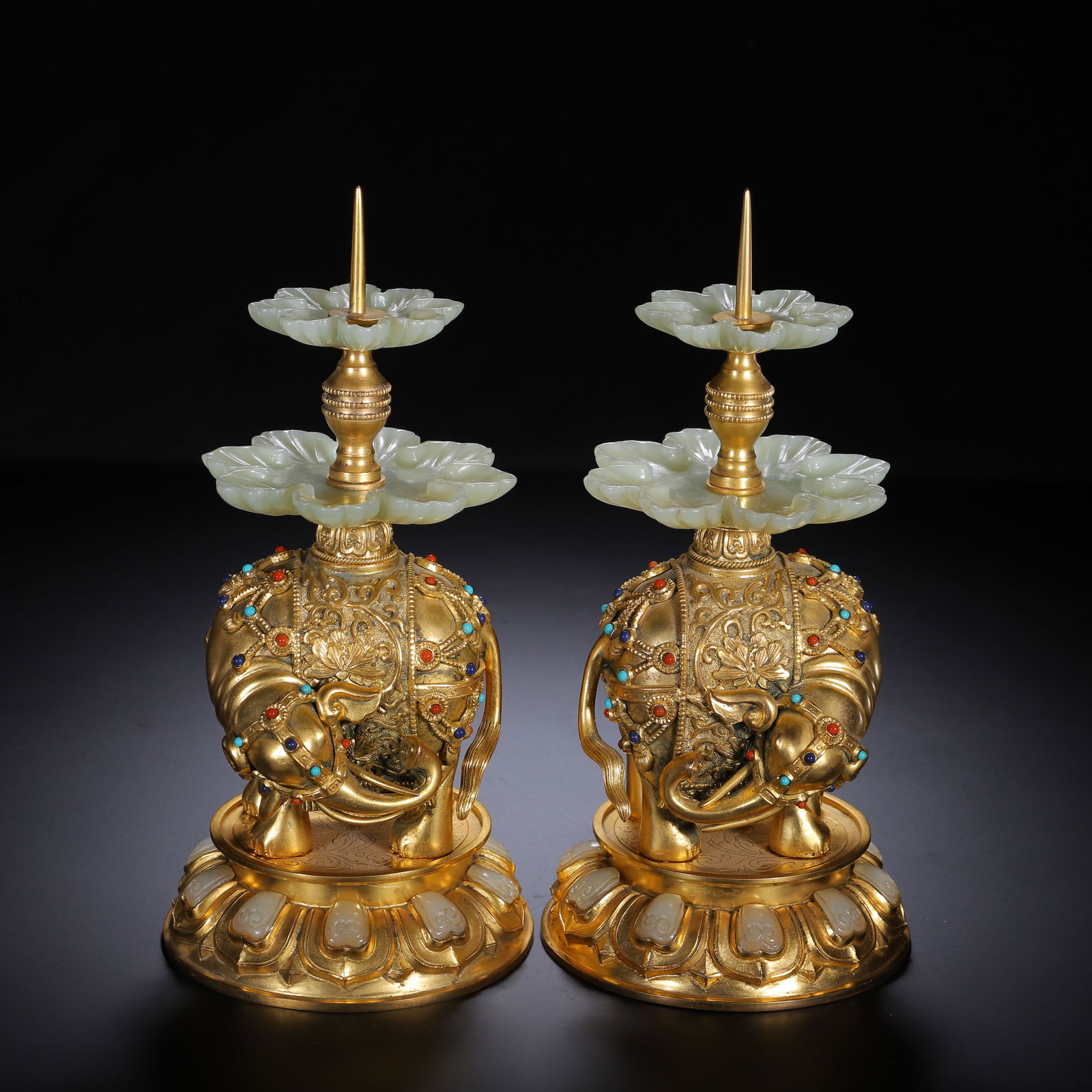 CHINESE GILT BRONZE JADE ELEPHANT PAIR: Dimensions: Diam. 10 cm. H. 21 cm. A charming pair of Chinese gilt-bronze elephant ornaments inset with jade, each measuring 10 cm in diameter and 21 cm in height. The elephants are cast in gilt