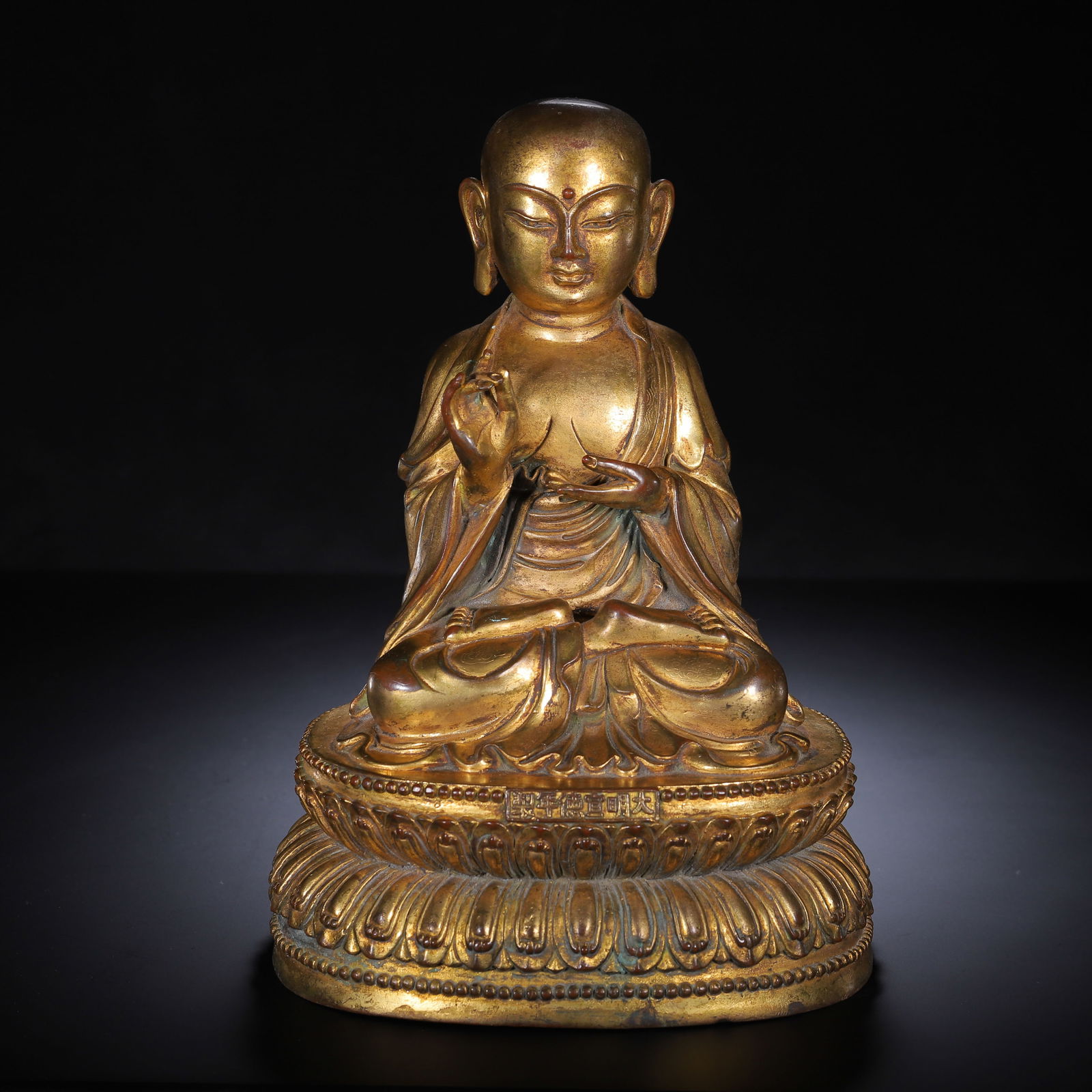 CHINESE GILT BRONZE KSITIGARBHA STATUE: Dimensions: H. 25 cm. Weight 2860 grams. This imposing Chinese gilt bronze statue of Ksitigarbha (Dizang) stands 25 cm high and weighs 2860 grams, cast in a classic meditative seated pose on a