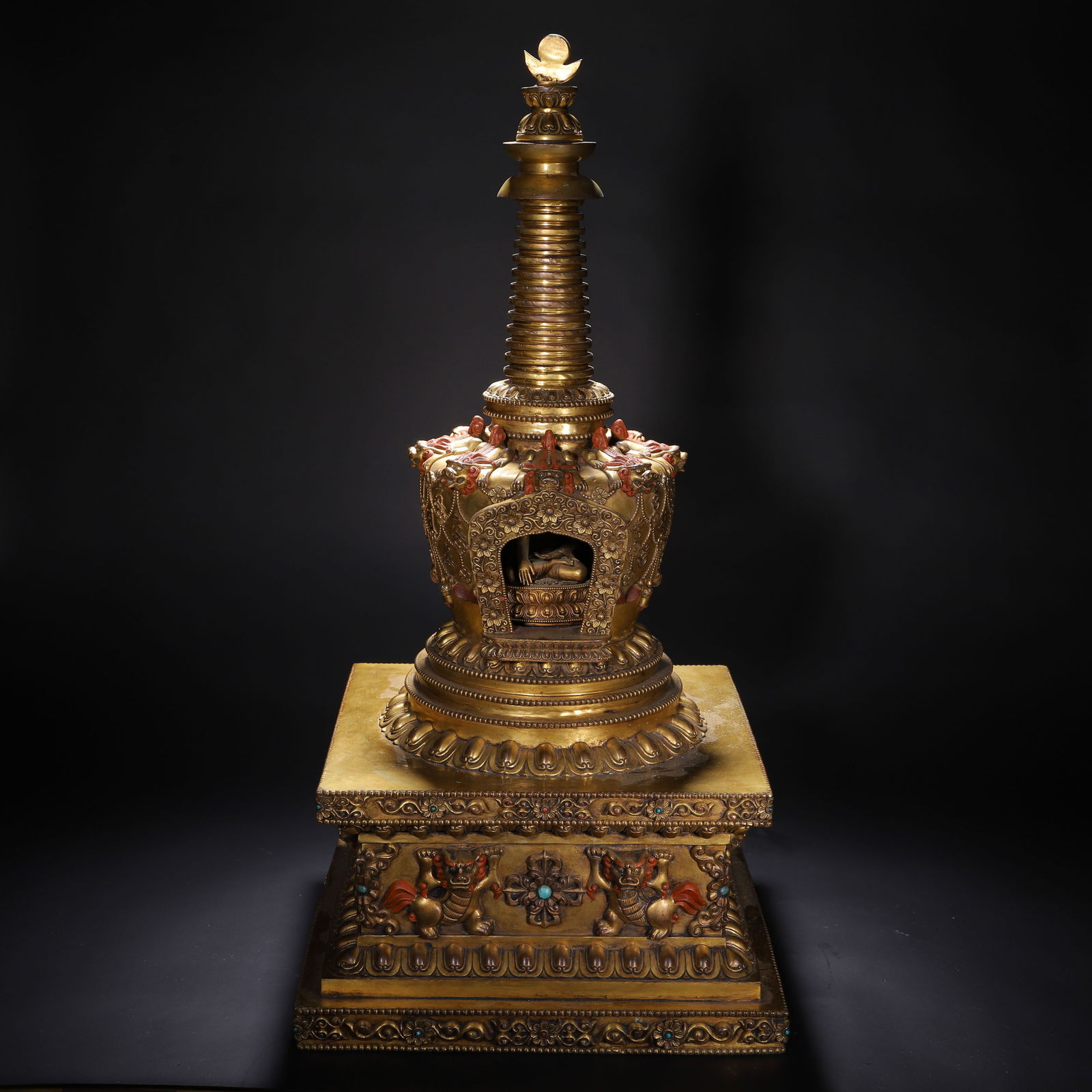 CHINESE GILT BRONZE TIBETAN STUPA: Dimensions: L. 40 cm. W. 40 cm. H. 82 grams. This imposing Chinese gilt bronze Tibetan stupa features a traditional dagoba form with a spiral spire topped by a lotus finial, a relic niche housing a sm