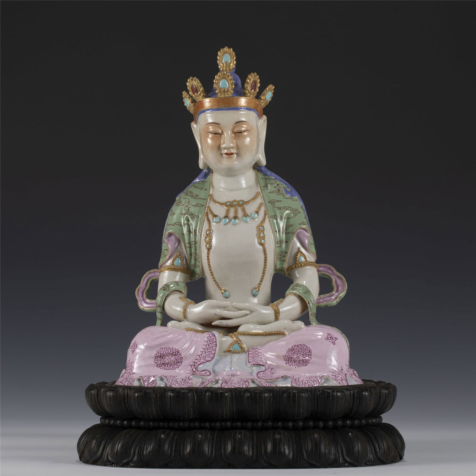 QING FAMILLE ROSE BUDDHA GUANYIN STATUE ON STAND: Measurements: Length: 18.8 cm, Width: 16.5 cm, Height: 26.5 cm Chinese Qing Dynasty Famille Rose Porcelain Buddha Guanyin Statue On Hardwood Stand. This statue of Buddha potted in a Peaceful face, smi
