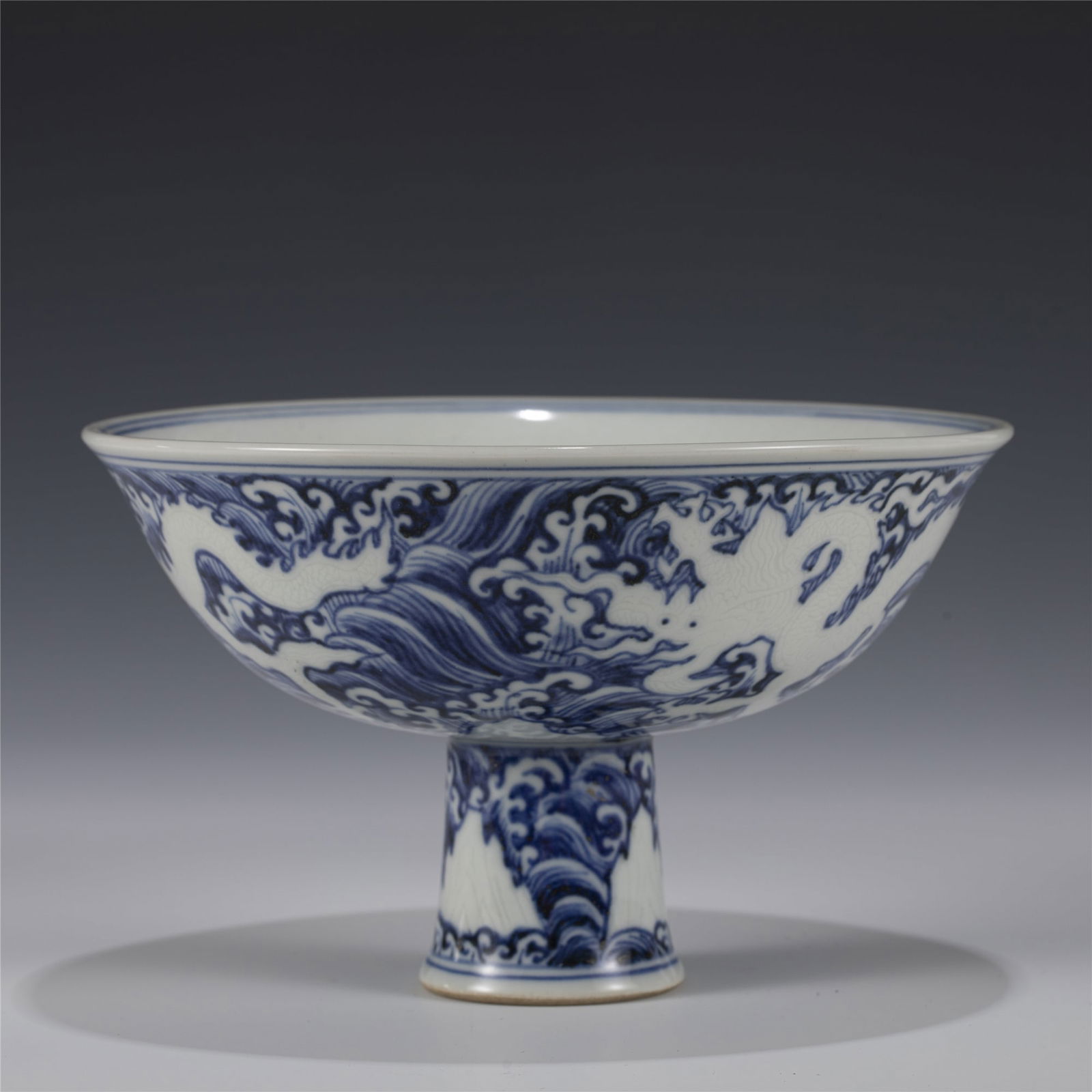 MING XUANDE BLUE & WHITE DRAGON TALL BOWL: Measurements: Length: 15.6 cm, Width: 15.6 cm, Height: 9.8 cm Chinese Ming Dynasty Xuande Blue and White Dragon Porcelain High Foot Bowl. Potted with a shallow deep body, thick, large and bulbous body
