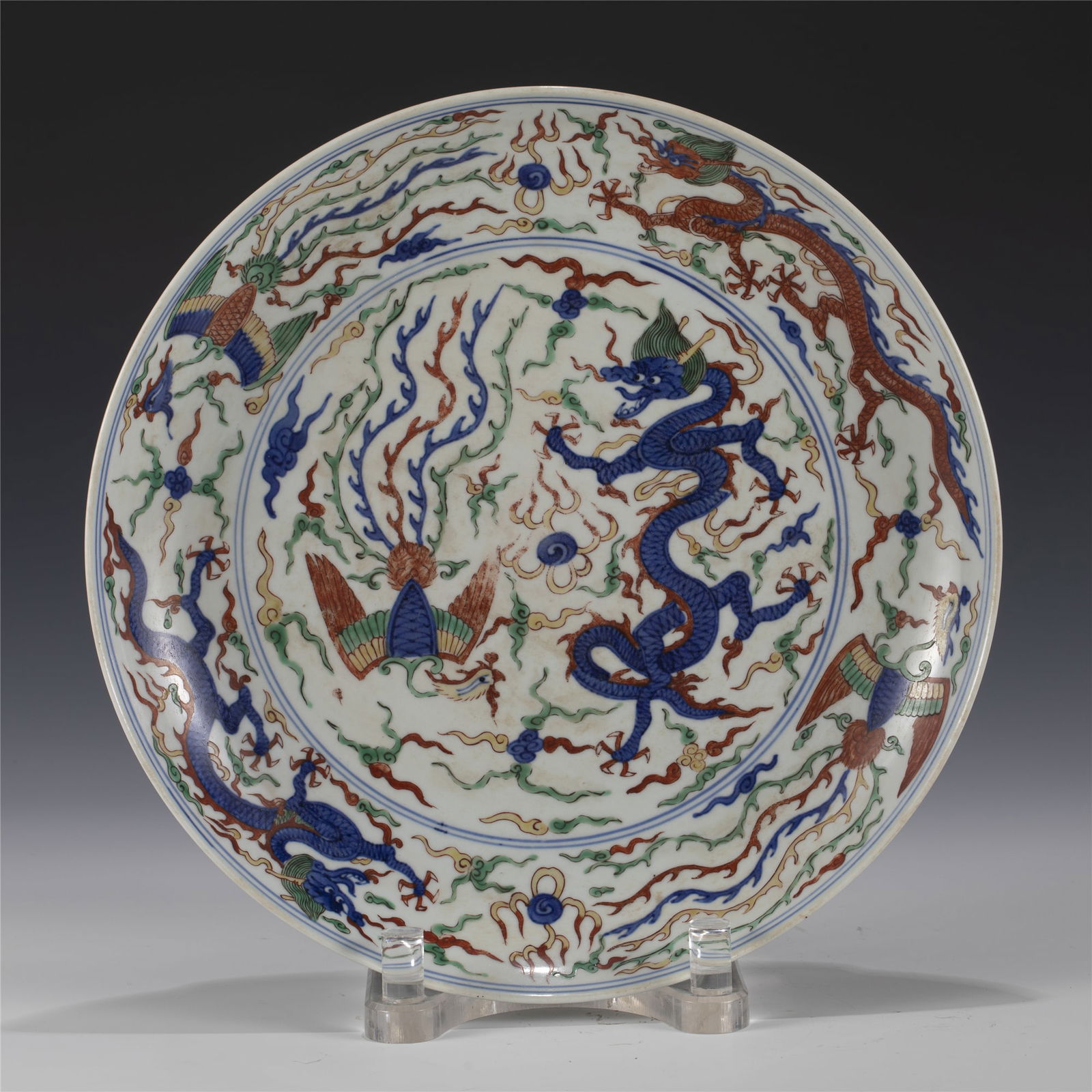 MING WANLI WUCAI PLATE: Measurements: Length: 32.8 cm, Width: 32.8 cm, Height: 5.2 cm Chinese Ming Dynasty Wanli Wucai Dragon and Phoenix Porcelain Plate. The dish plate has a broad wide central interior, rounded mouth lip,