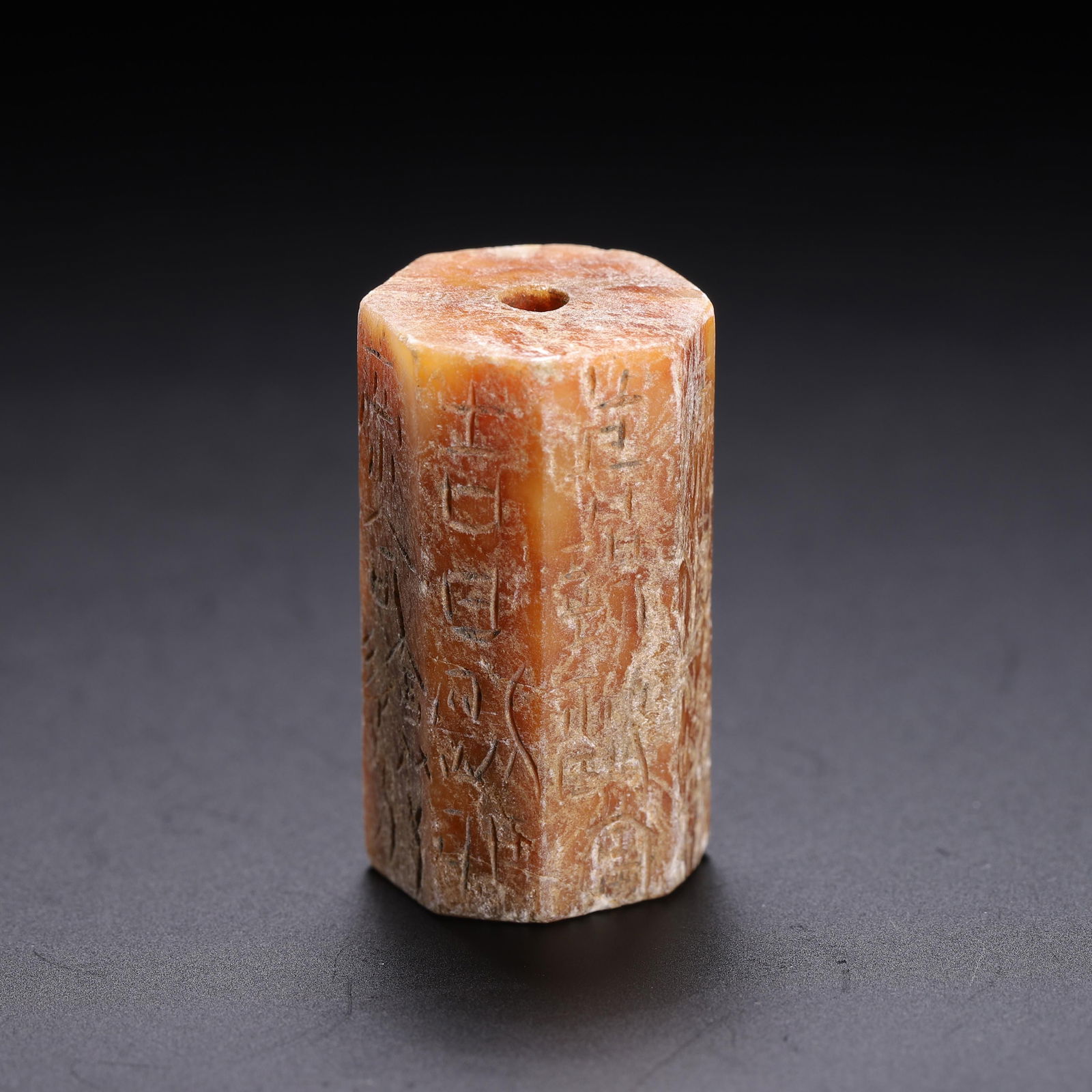 CHINESE ARCHAIC JADE LEZI BEAD: Dimensions: L. 1.5 cm. W. 1.5 cm. H. 3 cm. Weight 20 grams. This rare Chinese archaic jade lezi bead features an octagonal cylindrical form with incised pictographic inscriptions on each face, a