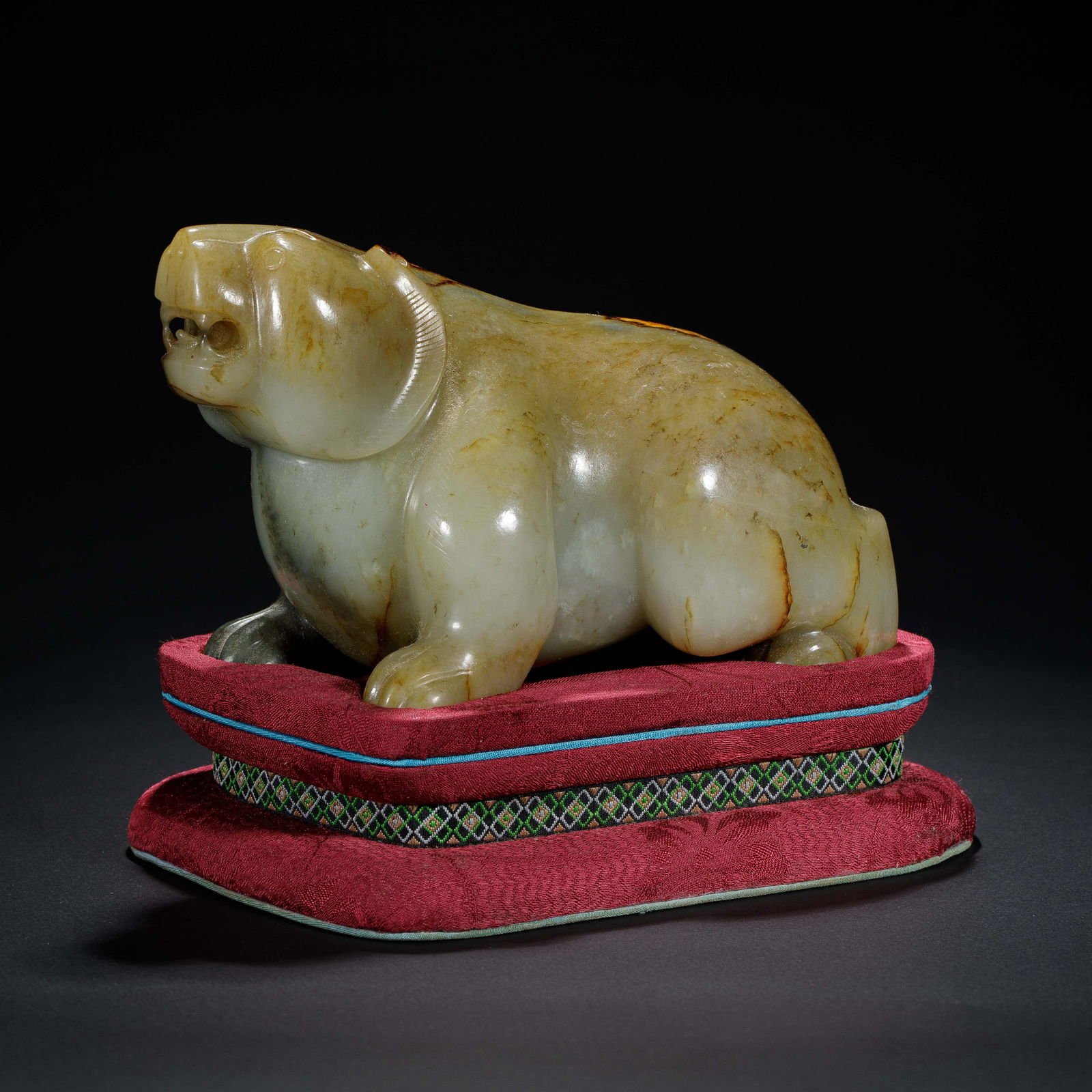 CHINESE HETIAN JADE BEAR ORNAMENT: Dimensions: L. 15.5 cm. H. 10 cm. Weight 1480 grams. This Chinese Hetian jade carving depicts a bear in a seated, powerful posture, a striking example of classical Chinese animal jade sculpture.
