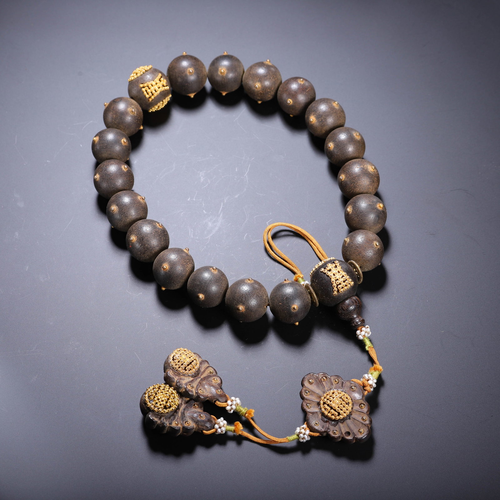 CHINESE AGARWOOD PRAYER BEADS: Dimensions: L. 1.8 cm. Weight 90 grams. This refined Chinese agarwood prayer bead strand features spherical agarwood beads (1.8 cm in diameter) with a rich, dark patina and natural aromatic wood grain