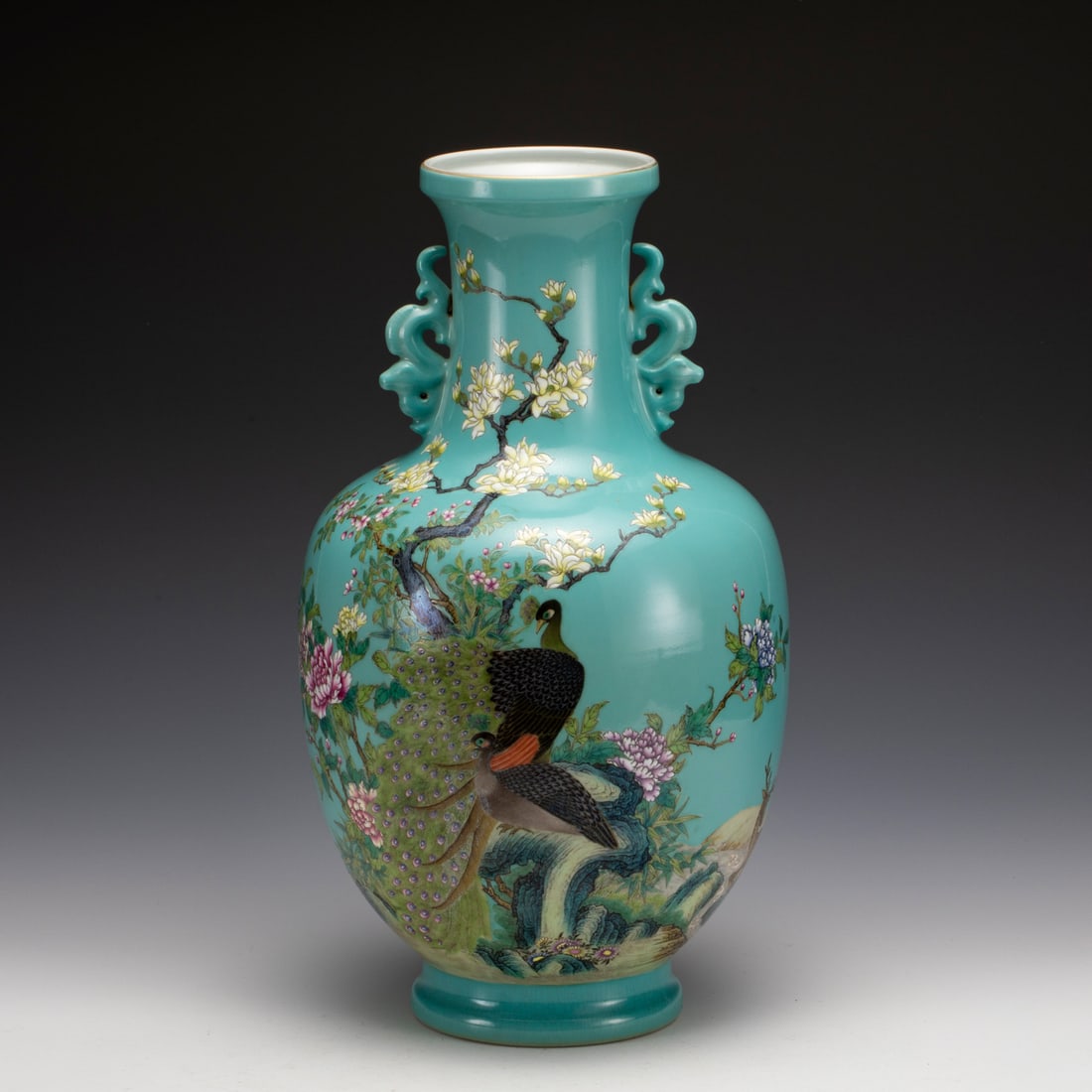 YONGZHENG FAMILLE ROSE PEACOCK AMPHORA VASE: Measurements: Width: 22 cm, Height: 39 cm Chinese Famille Rose Peacock Porcelain Amphora Vase. This vase has a flaring mouth-rim, a long cylindrical neck, a sloping shoulder with archaic dragon head g