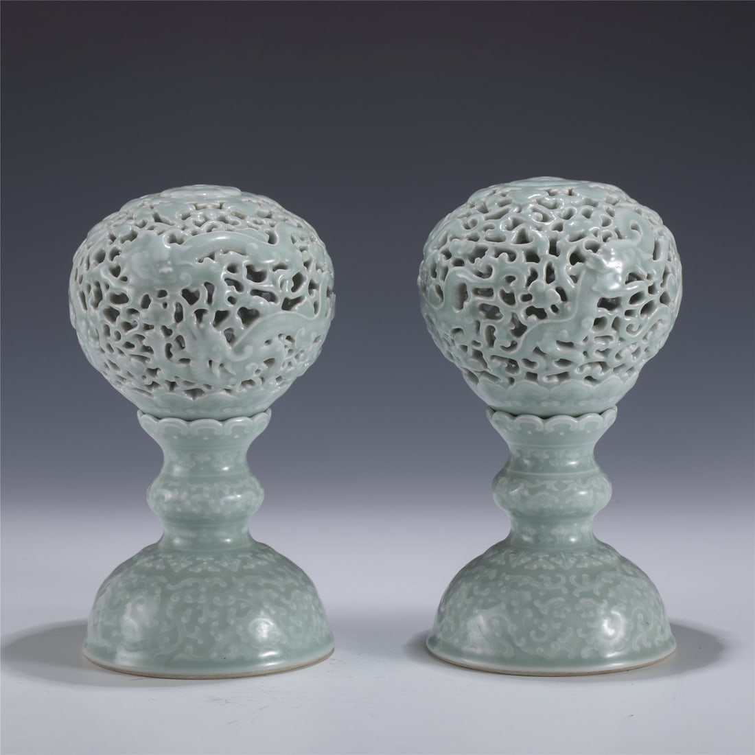 PAIR OF QIANLONG BEAN GREEN HOLLOW CANDLE: Measurements: Length: 12.8cm, Width: 12.8cm, Height: 23cm Pair of Chinese Qing Dynasty Qianlong Bean Green Porcelain Hollow Candle Pot. Potted in candle holders shape stand, tall spherical shaped,