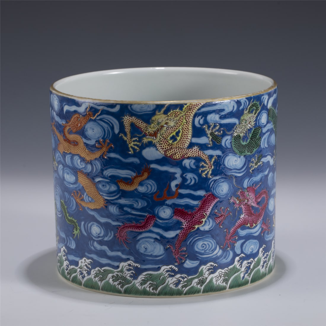 QIANLONG FAMILLE ROSE DRAGON BRUSH POT: Measurements: Length: 20.5cm, Width: 20.5cm, Height: 17.4cm Chinese Qing Dynasty Qianlong Famille Rose Dragon Porcelain Brush Pot. Potted in cylindrical body, thick, gently tapered to straight