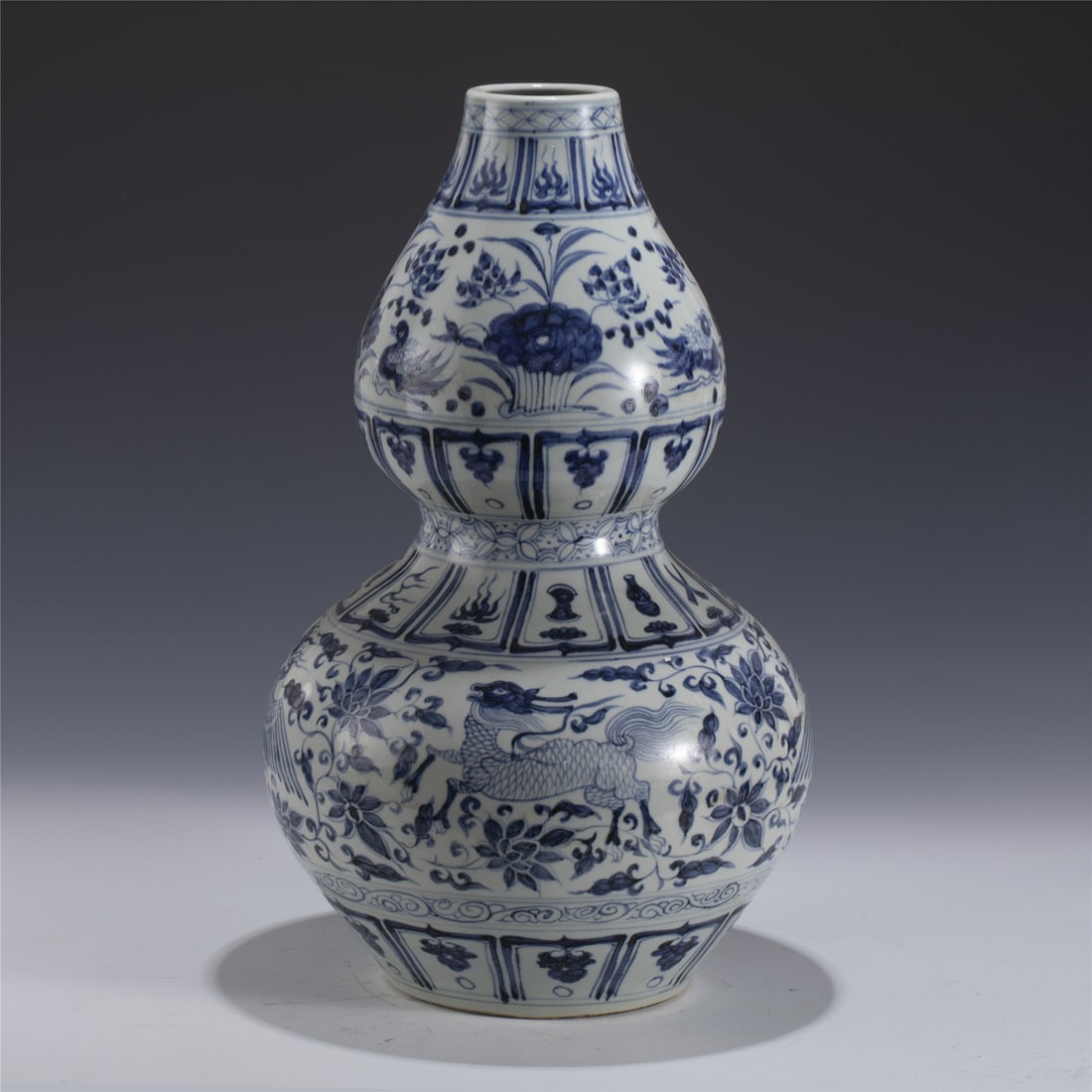 YUAN BLUE & WHITE GOURD VASE: Measurements: Length: 28cm, Width: 28cm, Height: 45.5cm Chinese Yuan Dynasty Blue and White Porcelain Gourd Bottle. Potted in a shape of double gourd resemblance, two bulbous bellies conjoined togethe