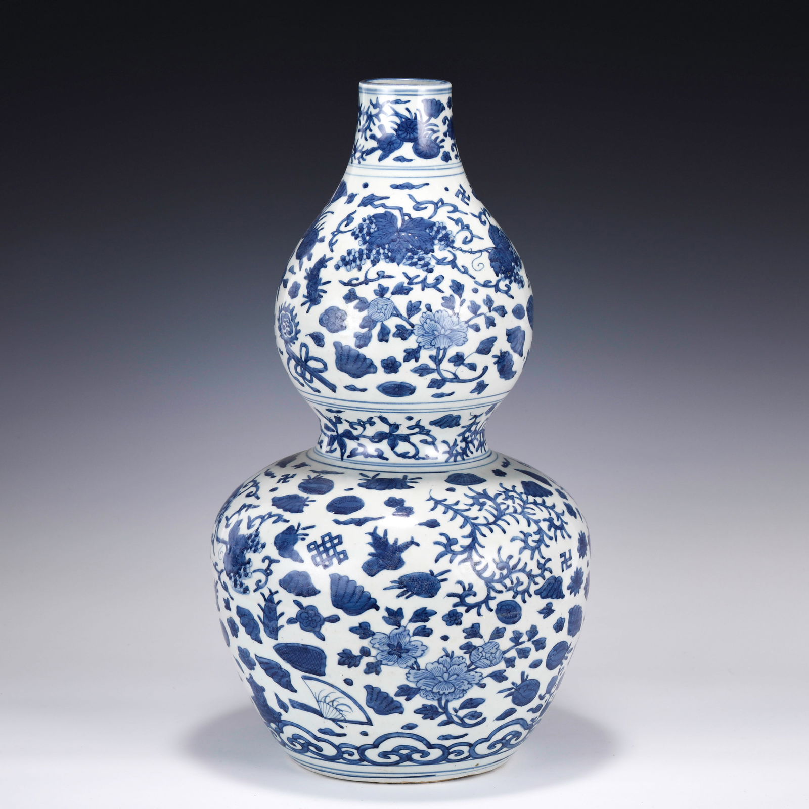 MING BLUE & WHITE GOURD BOTTLE: Measurements: Width: 28cm, Height: 50cm Chinese Ming Dynasty Blue and White Porcelain Double Gourd Bottle Vase. The porcelain potted with a shallow body, slight deep, thick, flaring rim with angled