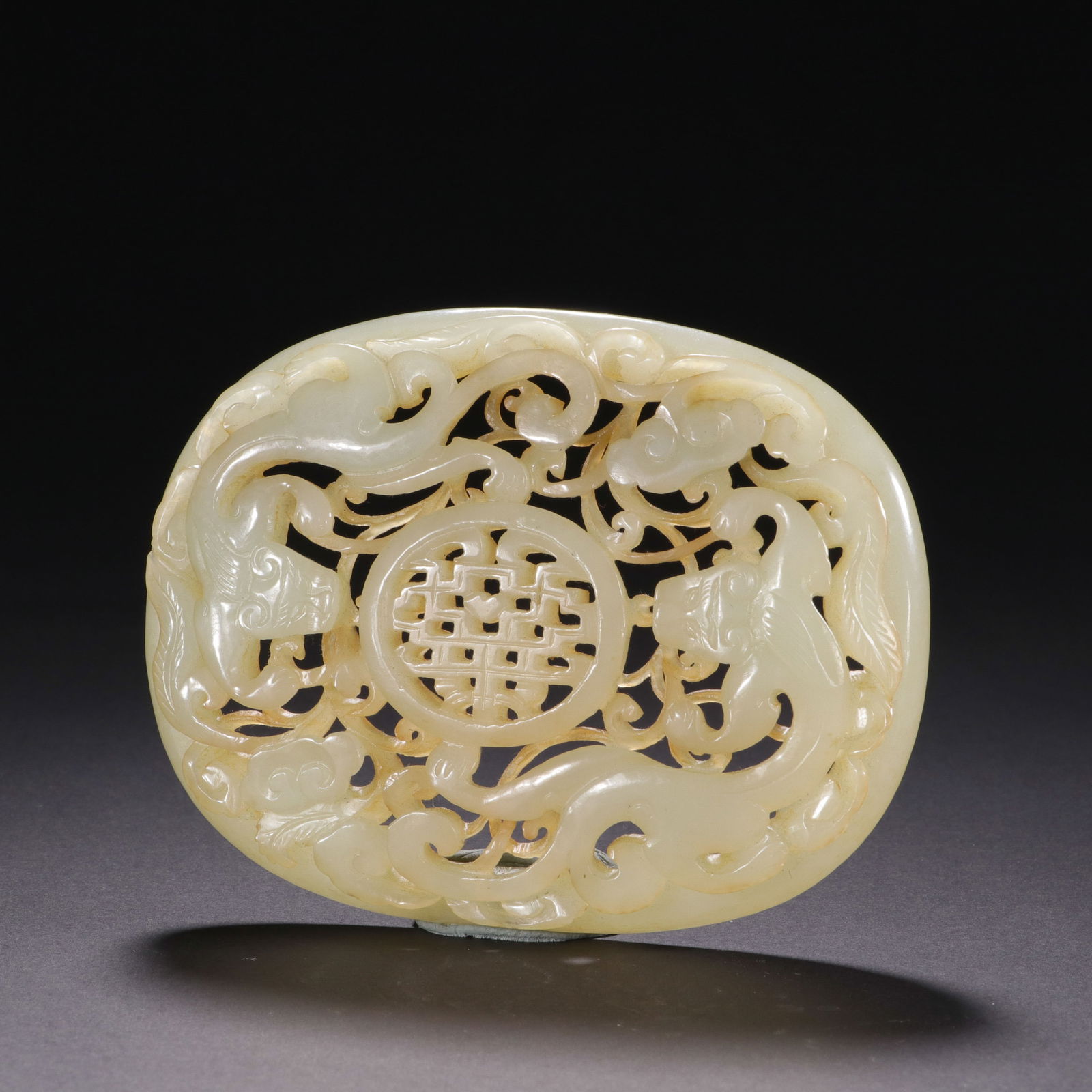 CHINESE HETIAN JADE DRAGON PLAQUE: Dimensions: L. 9.7 cm. W. 7.4 cm. This exquisite Chinese Hetian white jade plaque (wa zi) features openwork carving of twin chilong dragons encircling a central "xi" (double happiness) symbol, with fl