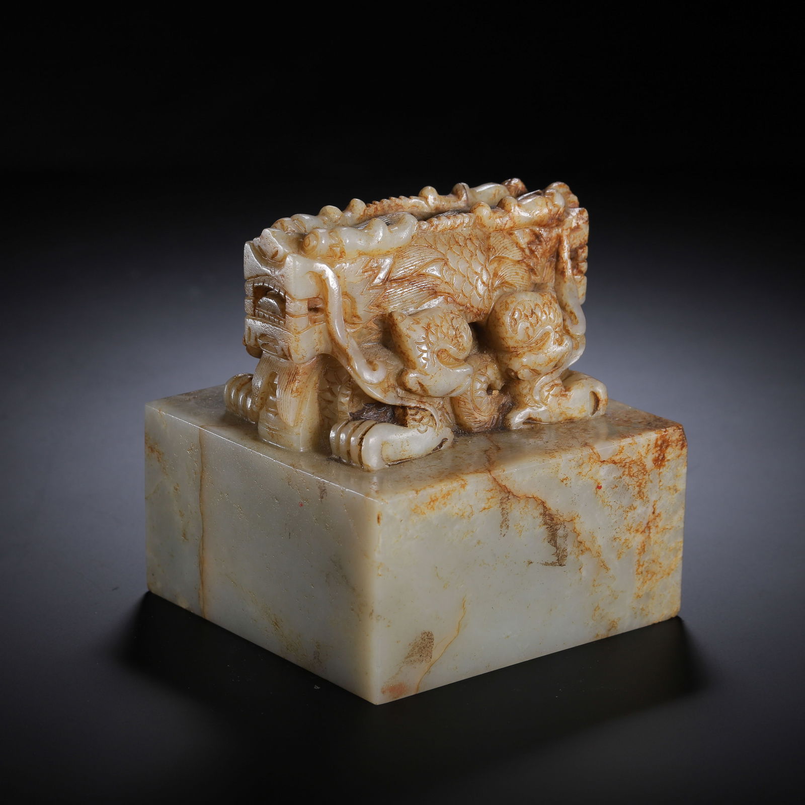 CHINESE HETIAN JADE DRAGON SEAL: Dimensions: L. 9.5 cm. W. 9.5 cm. H. 10 cm. Weight 1810 grams. This imposing Chinese Hetian jade seal measures 9.5 cm in length, 9.5 cm in width, 10 cm in height, and weighs 1810 grams, topped with a
