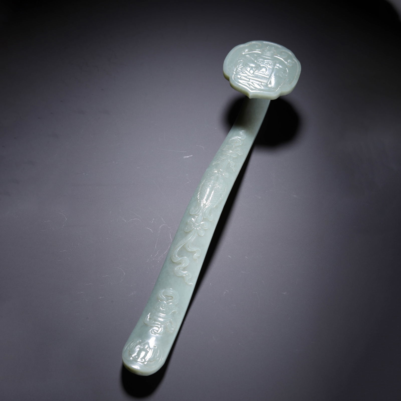 CHINESE HETIAN JADE RUYI SCEPTER: Dimensions: L. 34 cm. W. 7.2 cm. H. 5.5 cm. Weight 450 grams. This elegant Chinese Hetian jade ruyi scepter measures 34 cm in length, 7.2 cm in width, 5.5 cm in height, and weighs 450 grams, carved fr