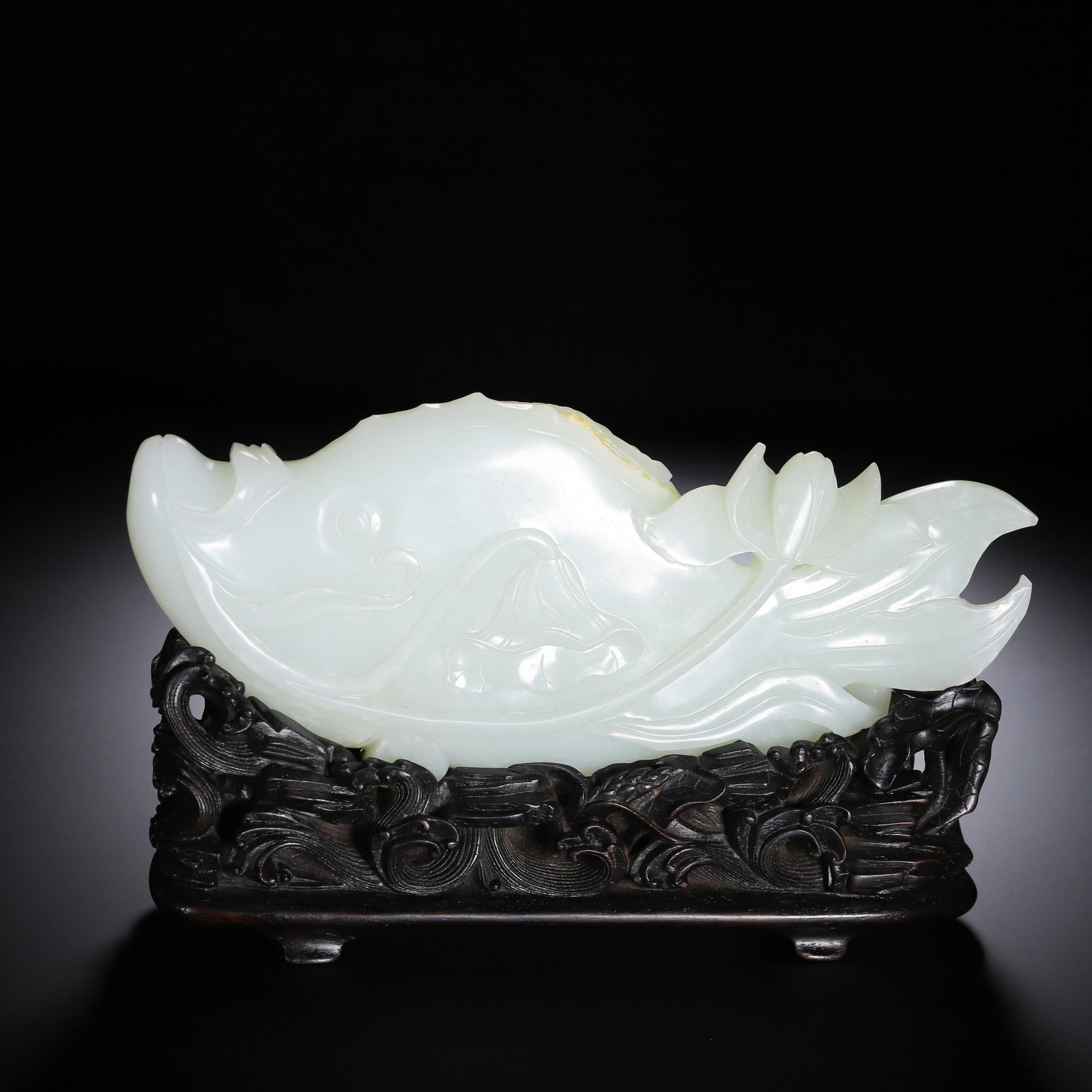 CHINESE HETIAN WHITE JADE FISH ORNAMENT: Dimensions: L. 21 cm. This impressive Chinese Hetian white jade fish ornament measures 21 cm in length, carved from a single piece of translucent pale white Hetian jade with a smooth, satiny finish. T